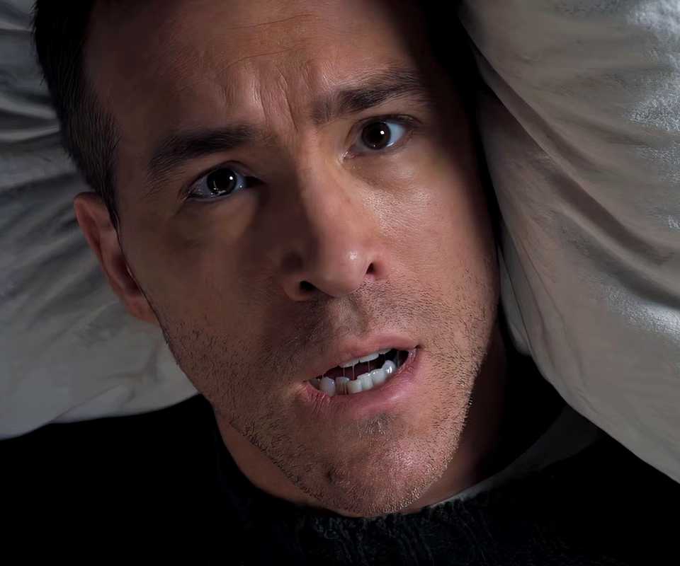 Ryan Reynolds waking up from bed in Mayday