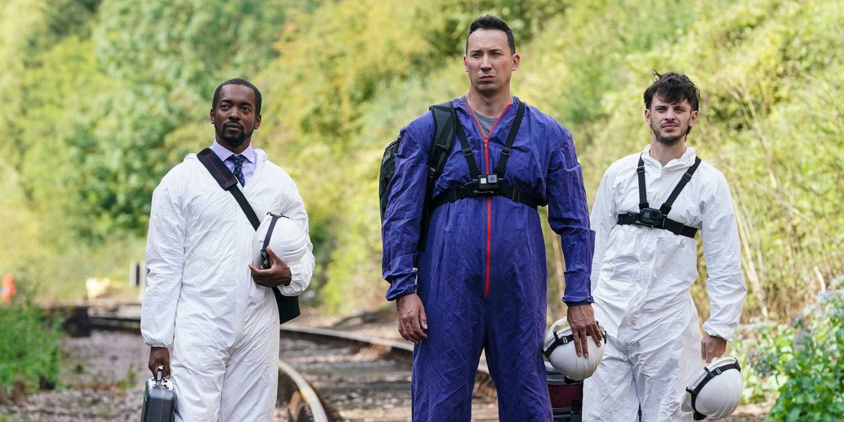 Silent Witness cast on a railroad track in forensic suits