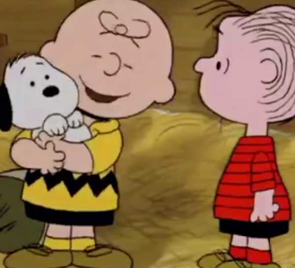 Charlie Brown hugging Snoopy in the Peanuts animated special Snoopy's Reunion