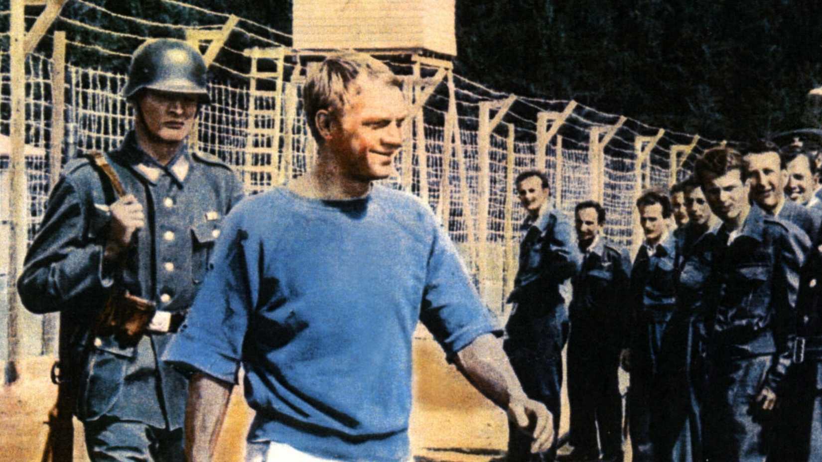 Steve McQueen walks in front of the prisoners in The Great Escape