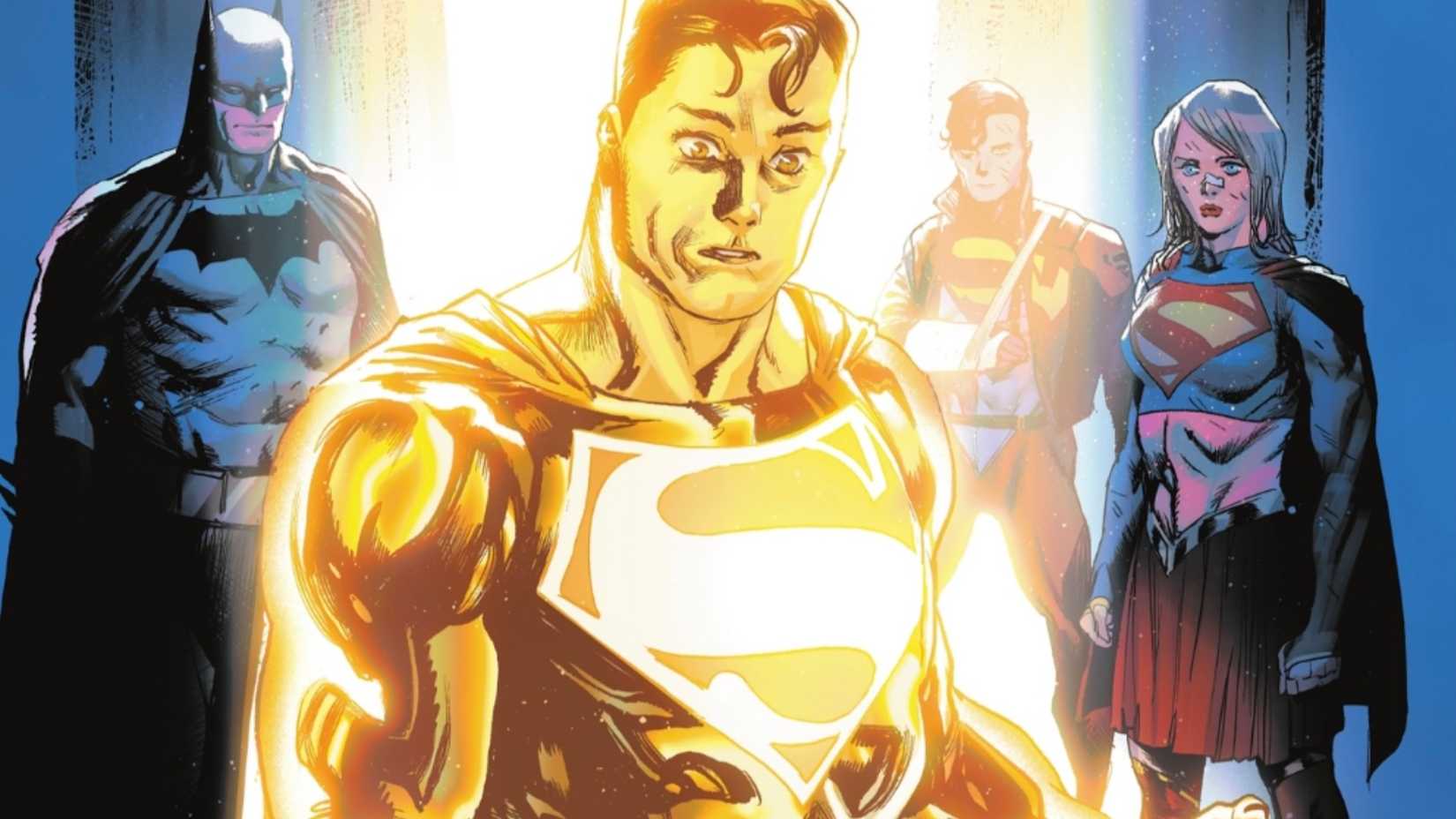 Superman in his gold form while Batman, Superboy, and Supergirl watch him