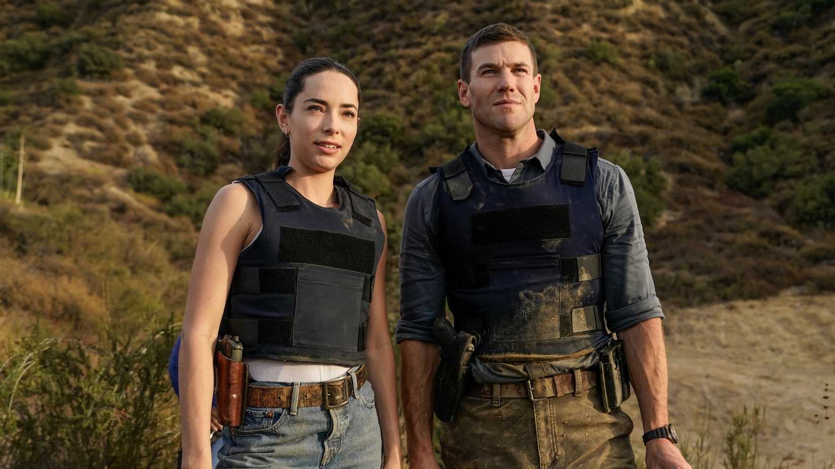 Gibbs and Lala standing outside wearing bulletproof vests