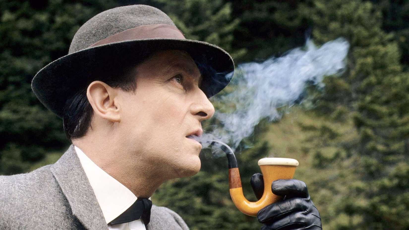 Sherlock Holmes (Jeremy Brett) smoking a pipe in Sherlock Holmes.