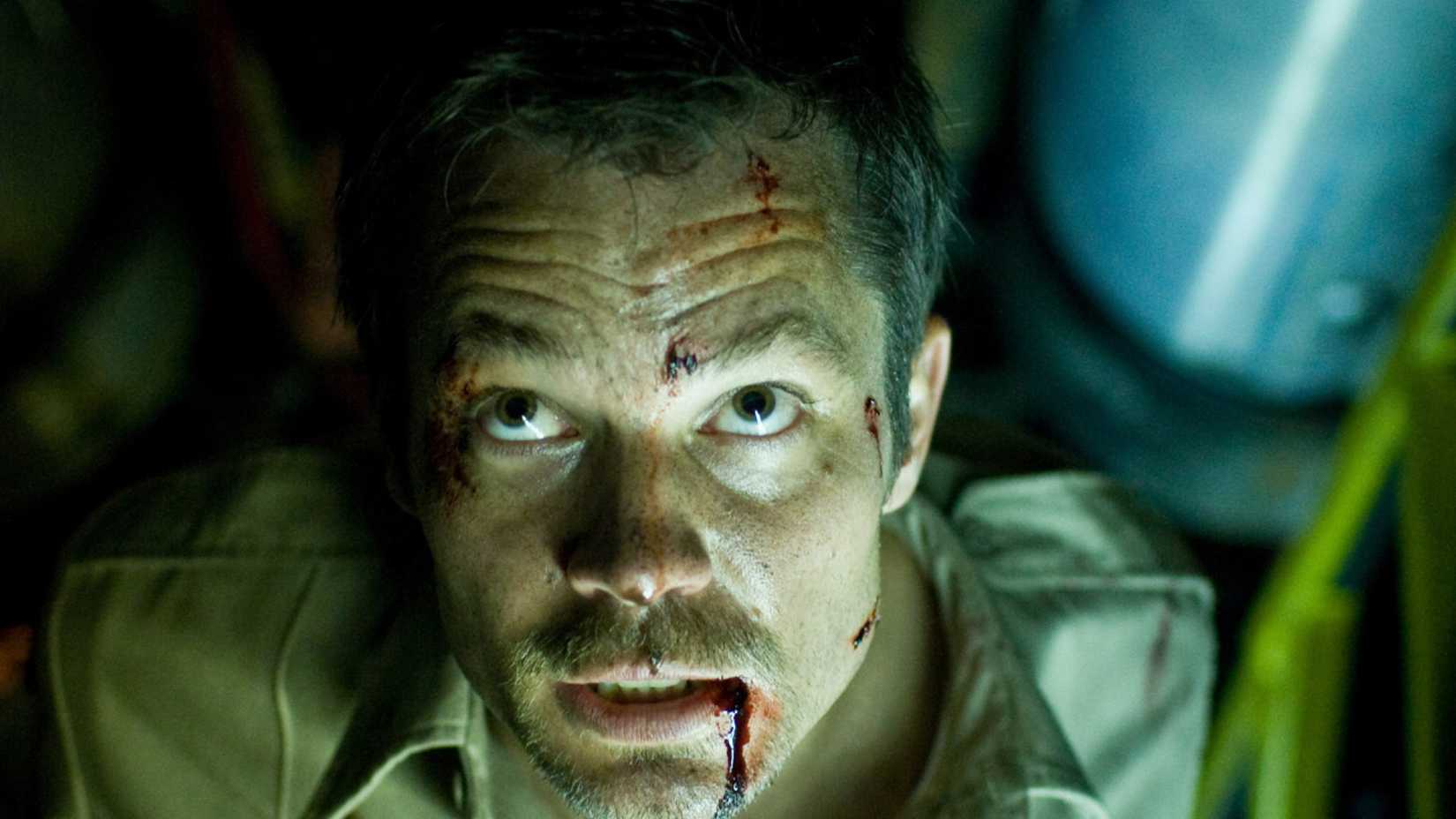 Timothy Olyphant looking up with blood on his face in The Crazies (2010).