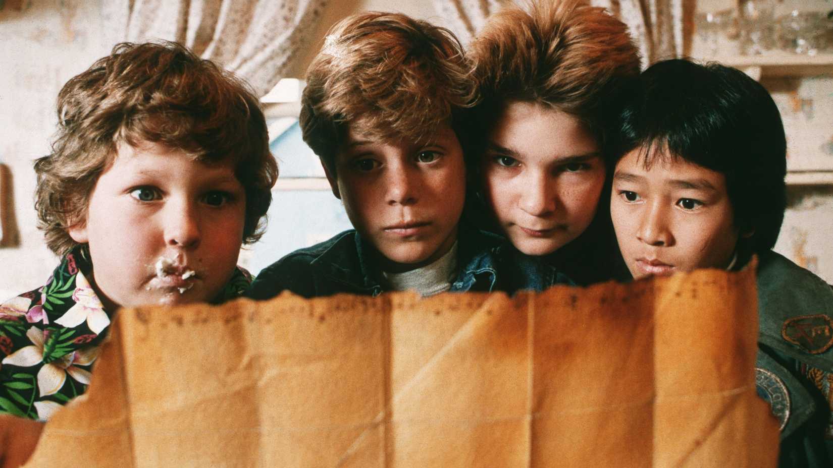 The Goonies kids staring at a map.