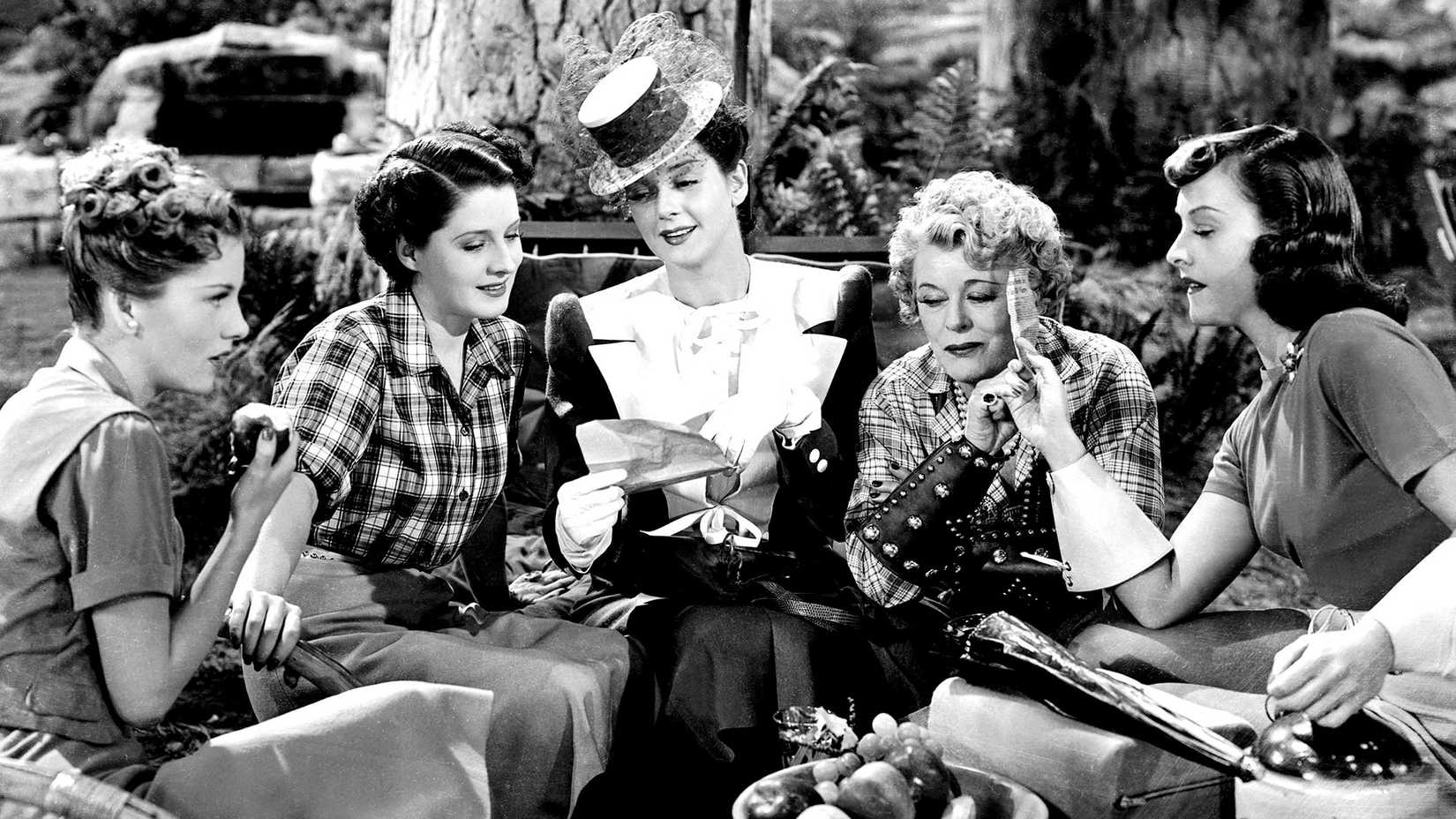 The main cast of The Women sitting together and talking