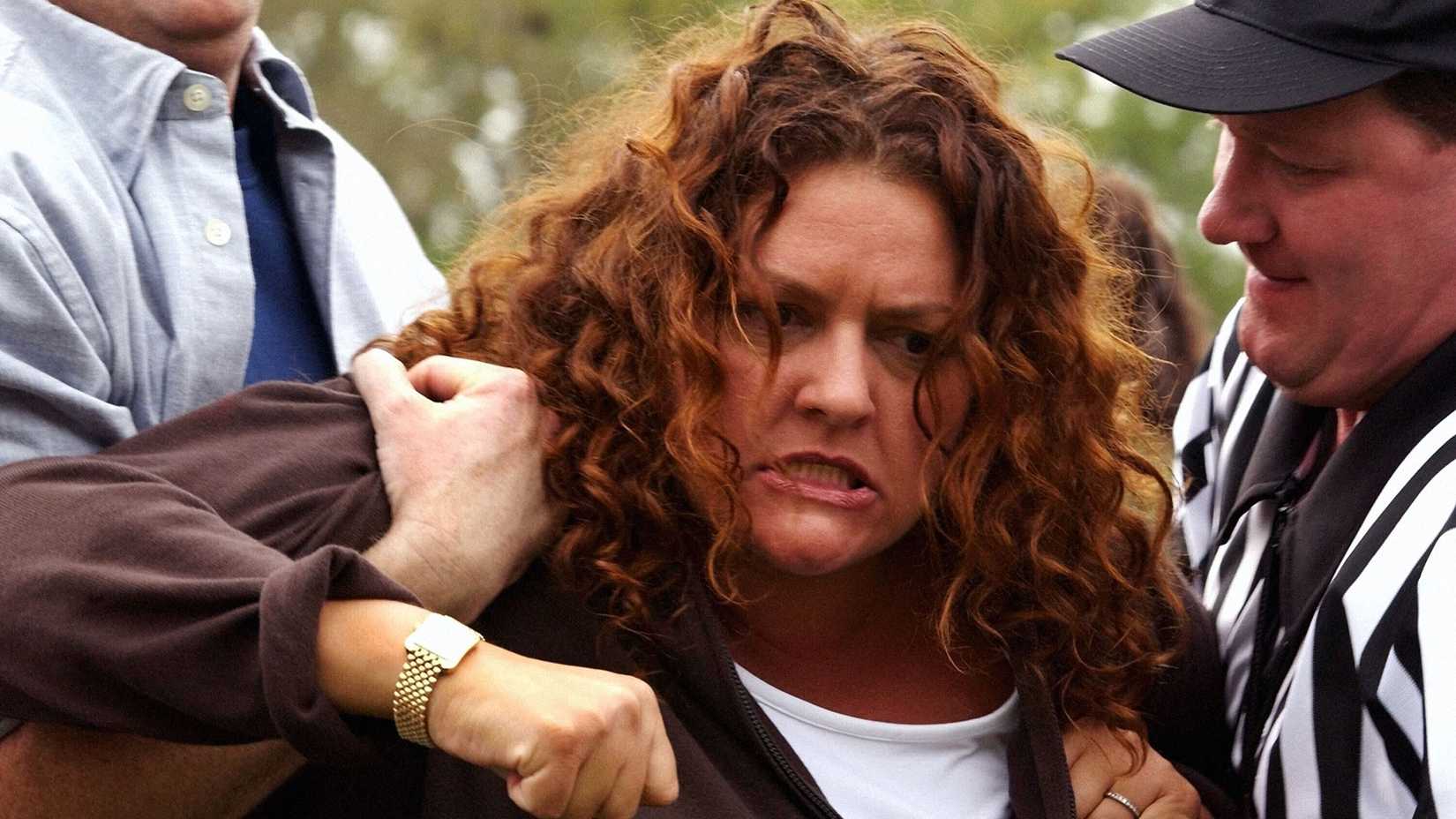Janice (Aida Turturro) beinbg held back by a ref and looking furious in The Sopranos, Cold Cuts.