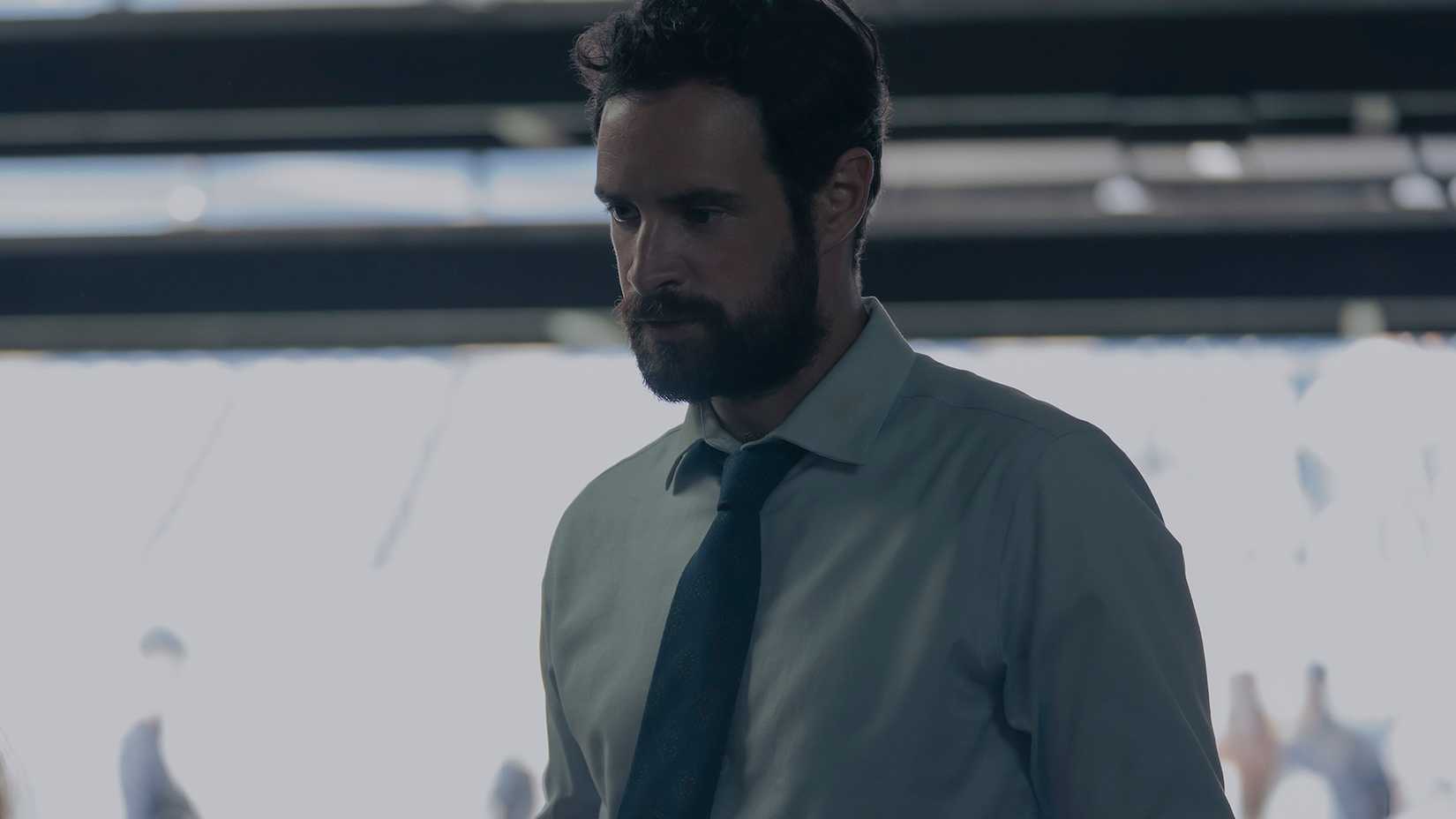 Commander Michael Judd wearing a collared shirt and tie