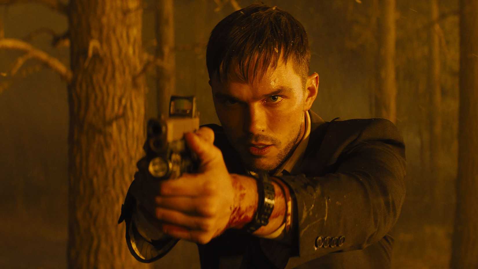Patrick (Nicholas Hoult) pointing a gun in Those Who Wish Me Dead.