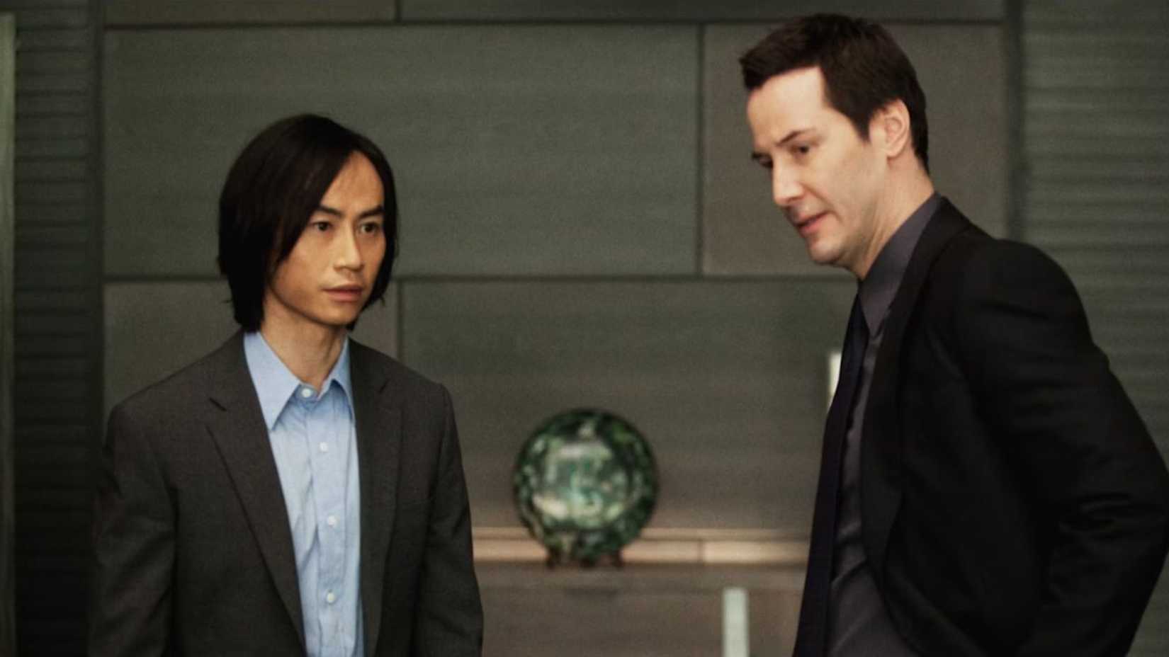 Tiger Chen standing next to Keanu Reeves in Man of Tai Chi