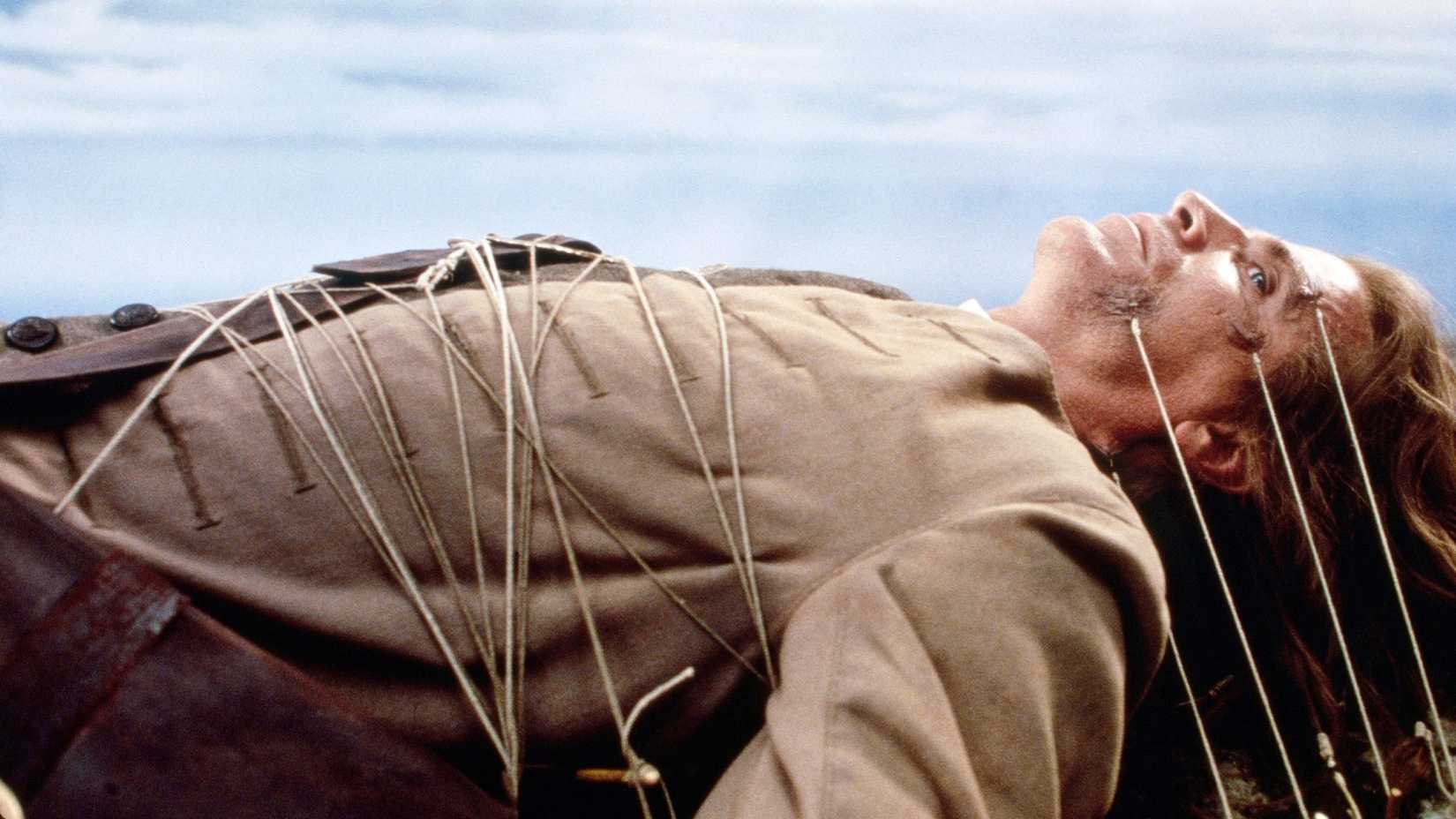 Gulliver (Ted Danson) tied to the ground in Gulliver's Travels.