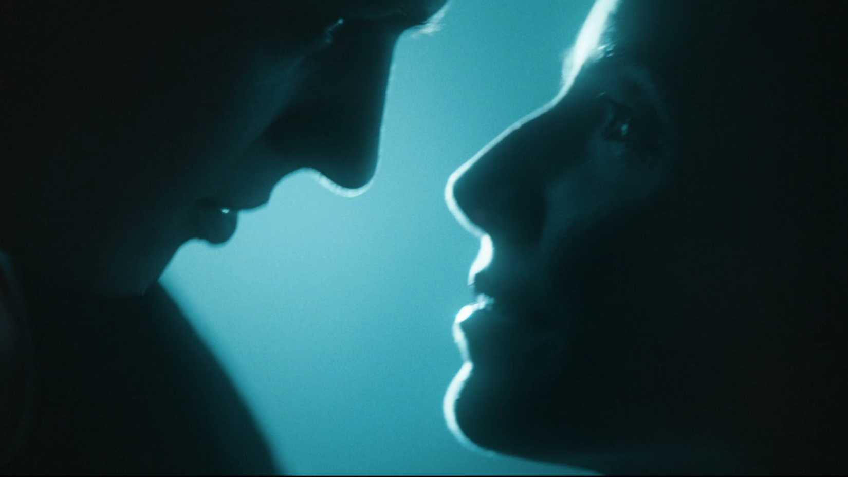 Two people about to kiss in You and Me Against the World