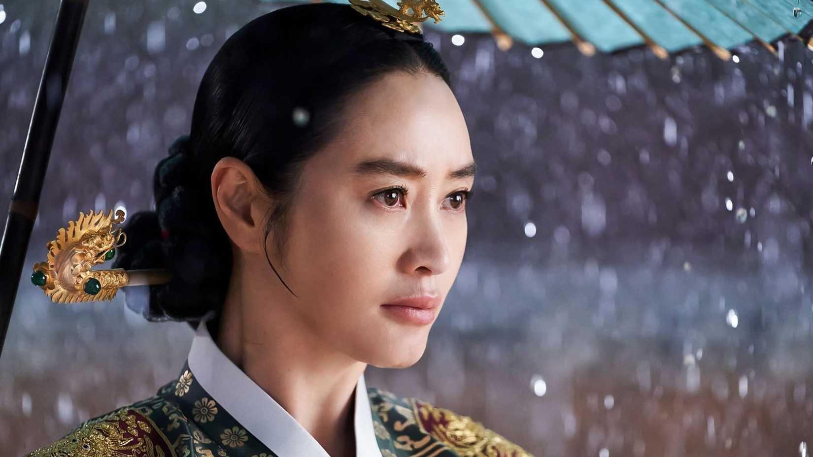 A woman shields herself from the rain in the historical K-drama Under The Queen's Umbrella.
