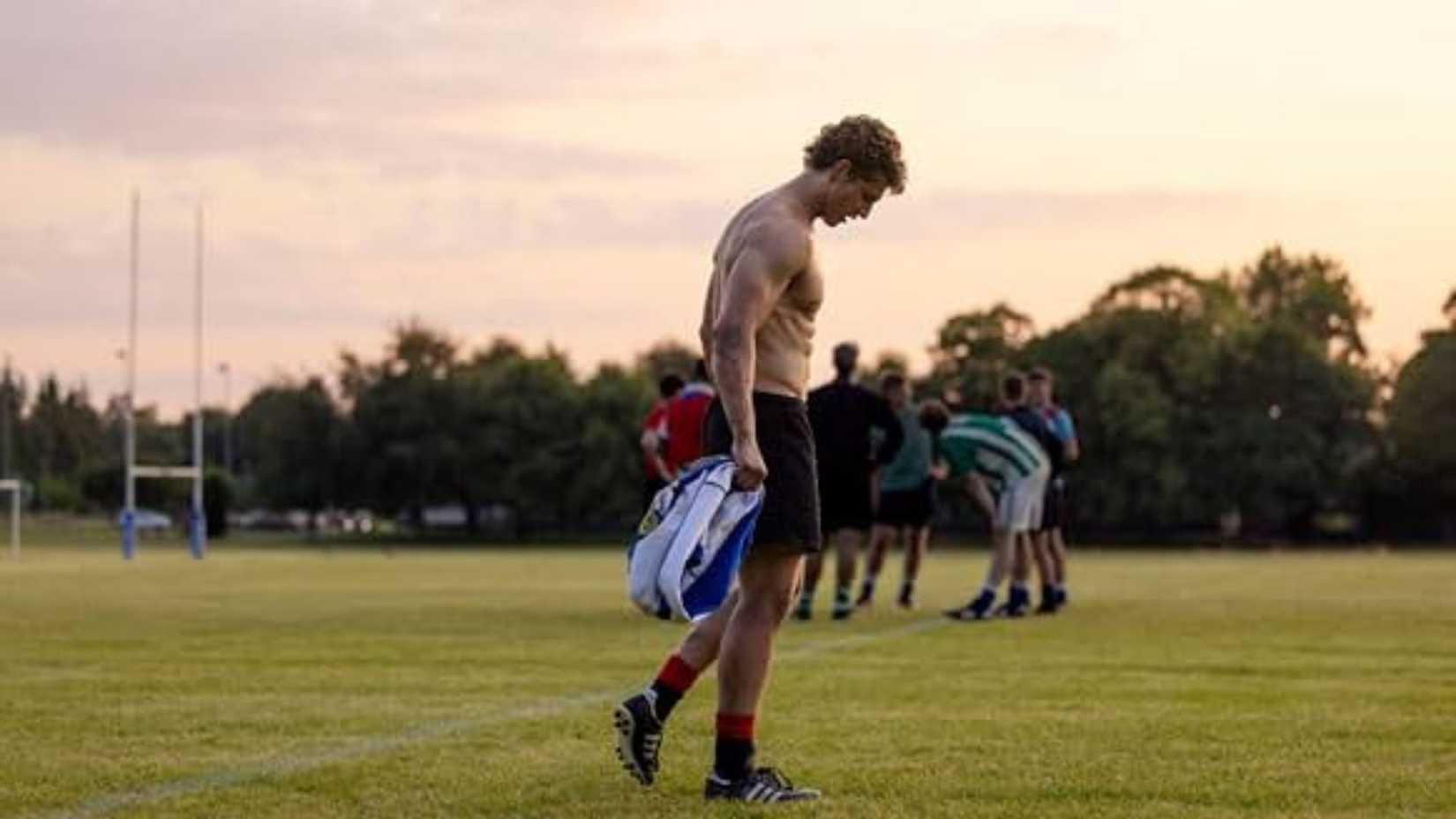 A young shirtless man on a field in Boys of Tommen