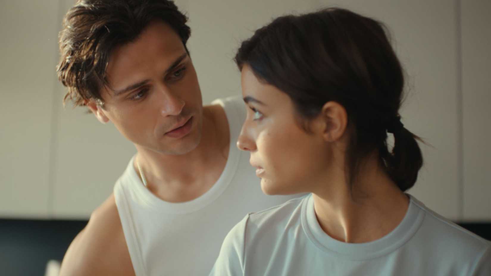 A young man and a young woman looking at each other in Campus Drivers