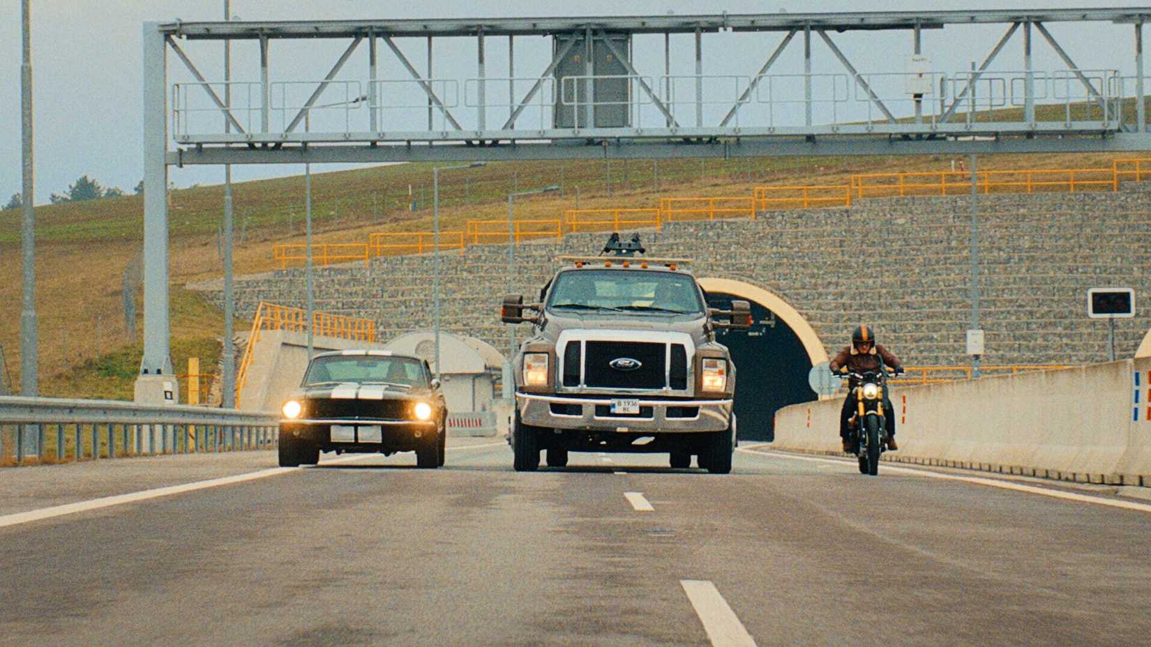 Vehicles driving down the road in Matchbox: The Movie