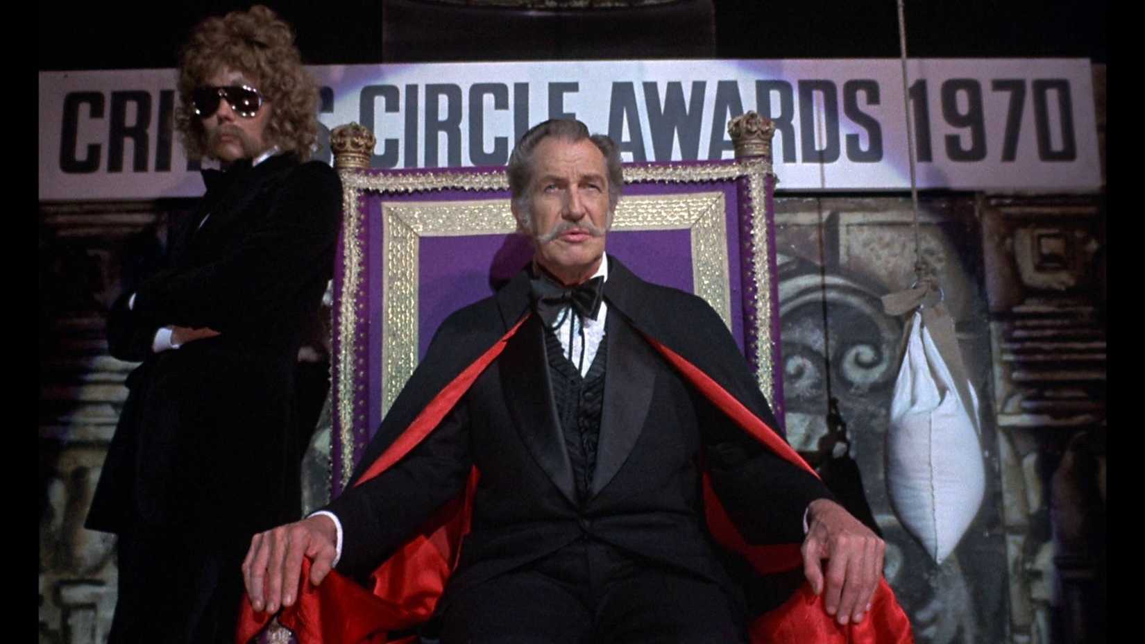 Vincent Price sat in a throne in a cape in Theatre of Blood