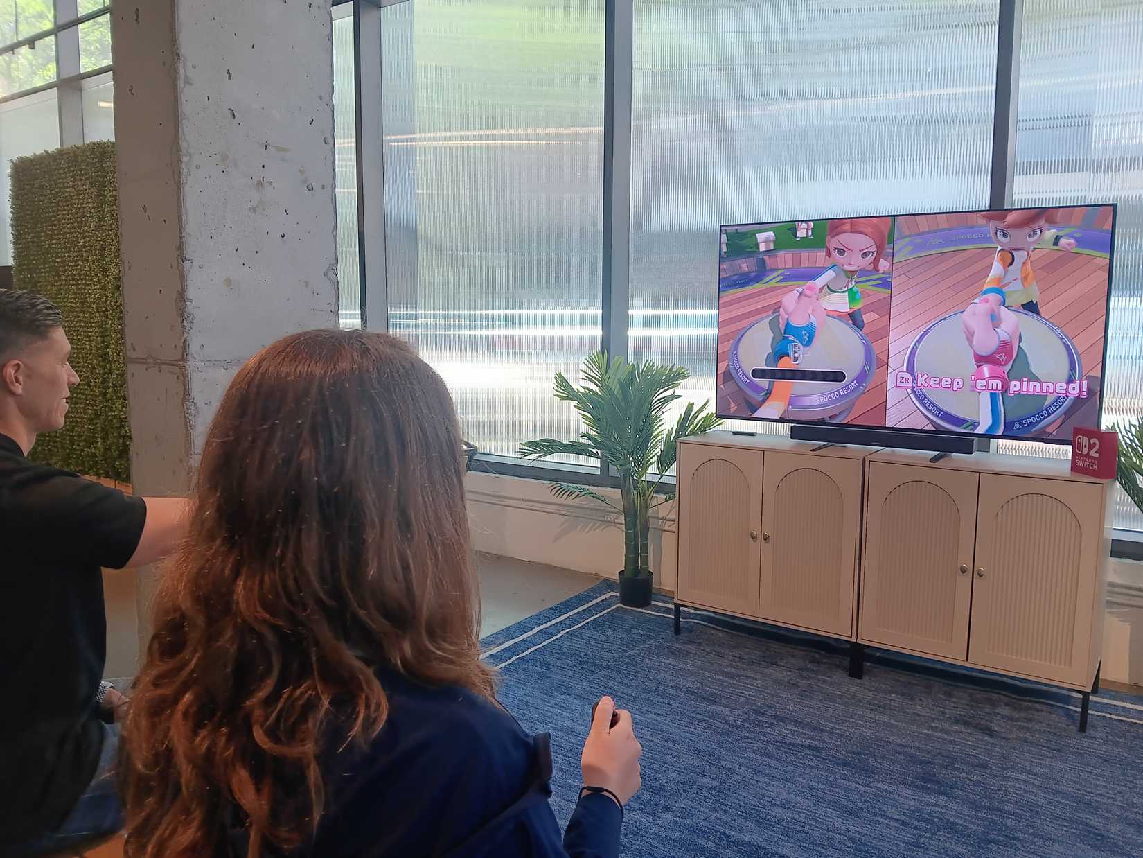 Two people playing the thumb wrestling game in switch sports resort
