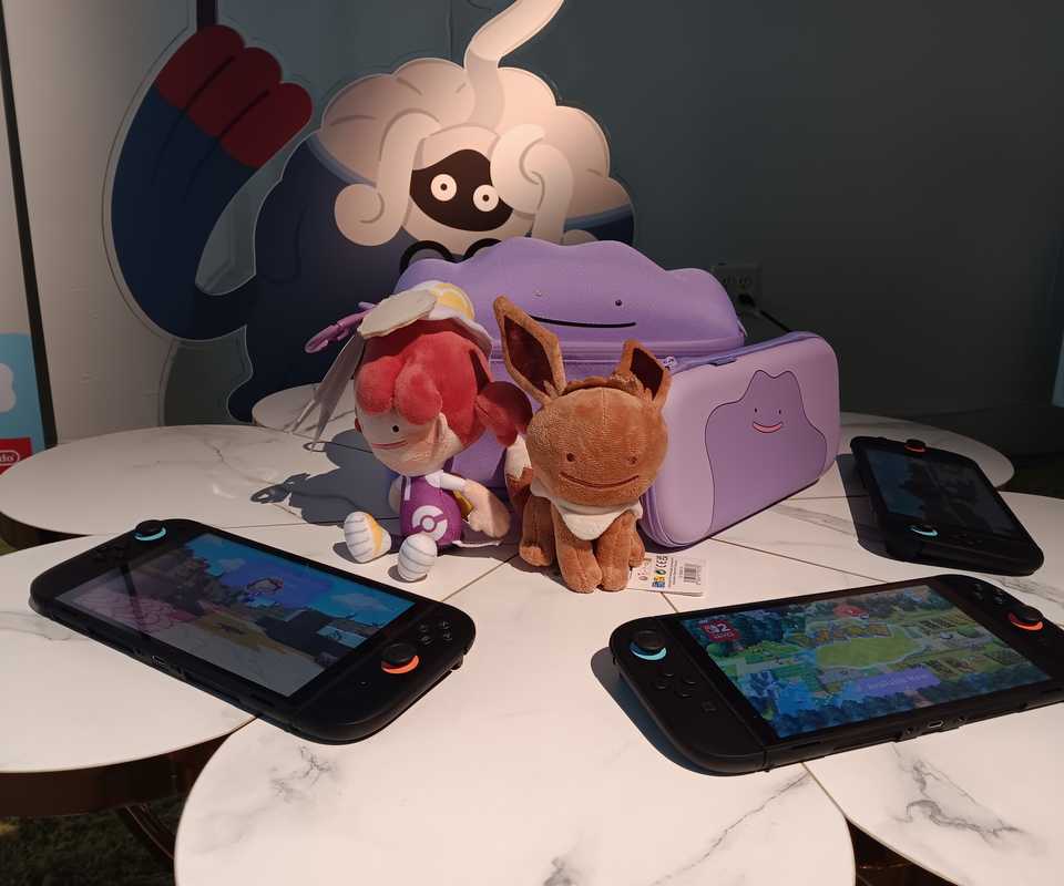 Pokemon Pokopia plushies and merch next to Nintendo Switch 2 consoles
