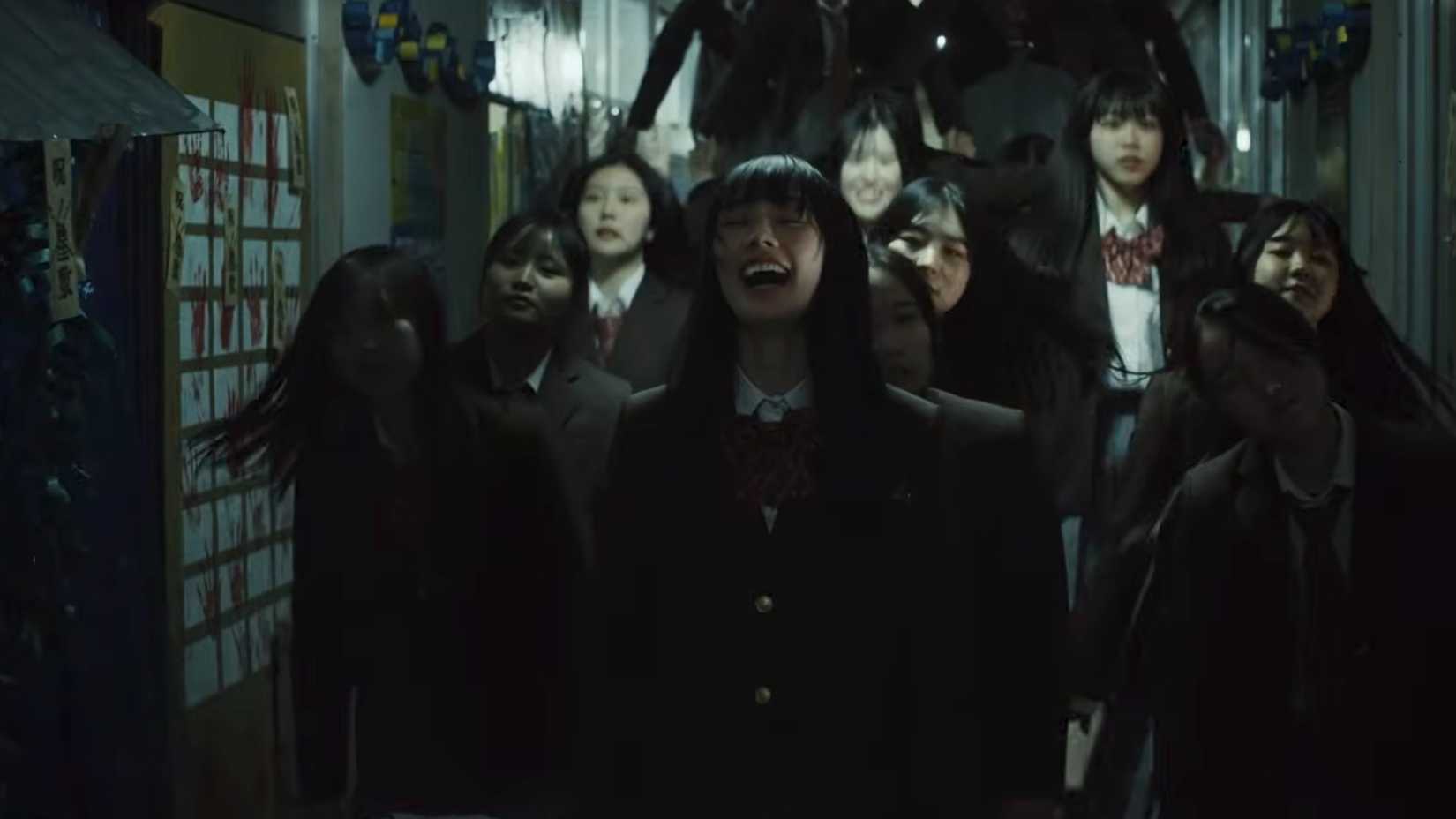 A girl laughing with other people behind her in New Group