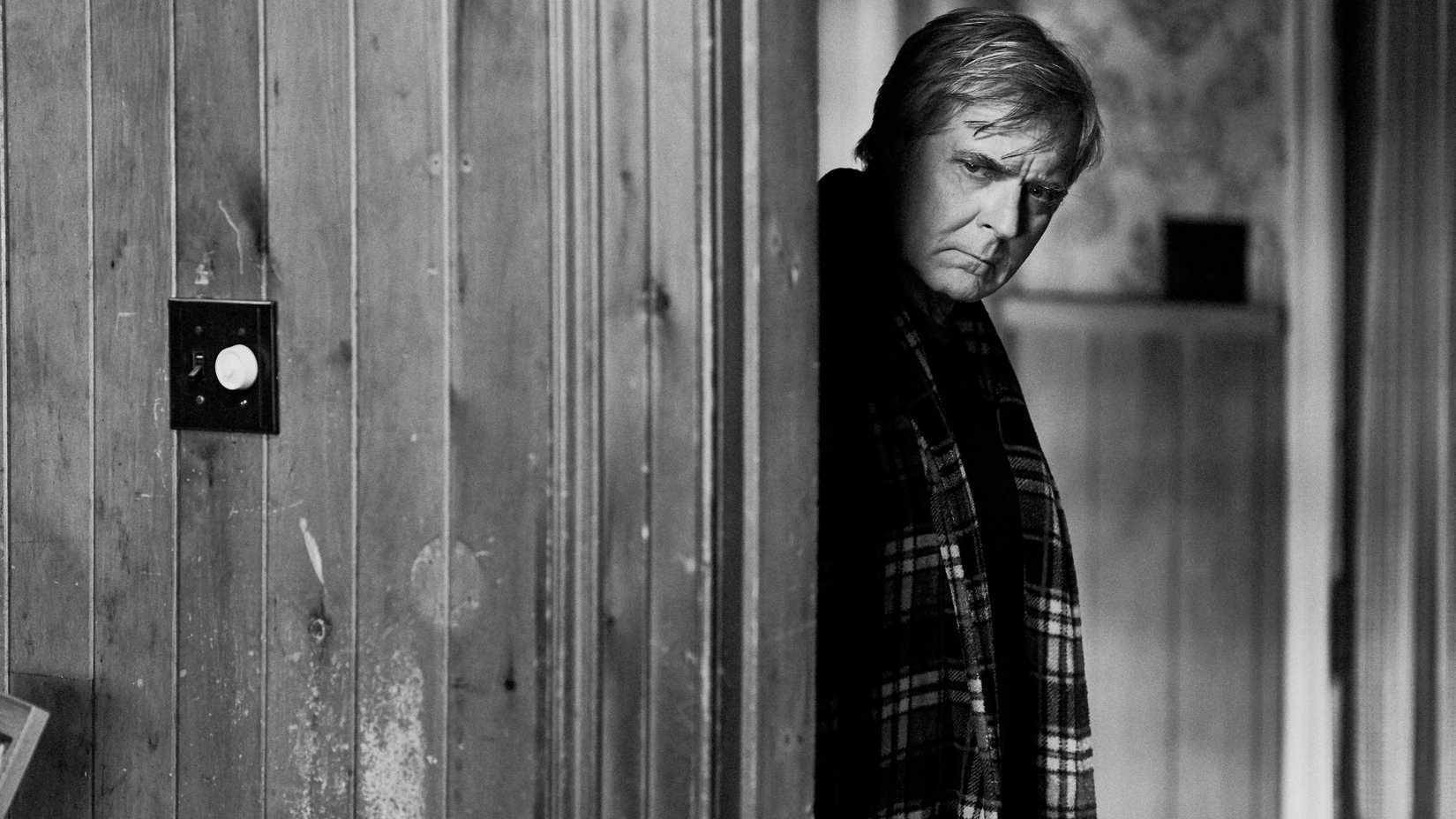 A man peers around a corner in The Righteous (2021)
