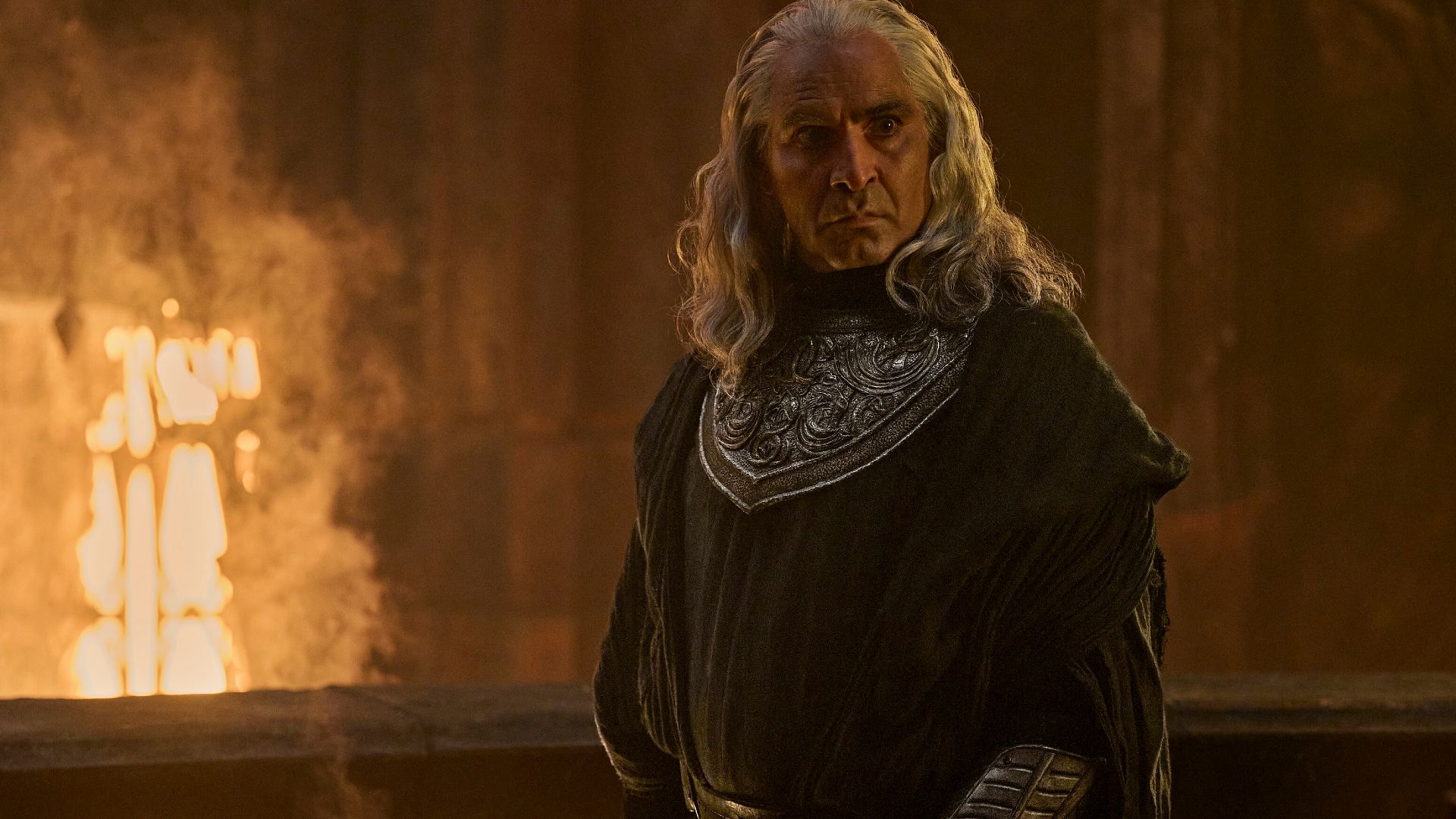 A man with white hair by a forge in The Rings of Power.