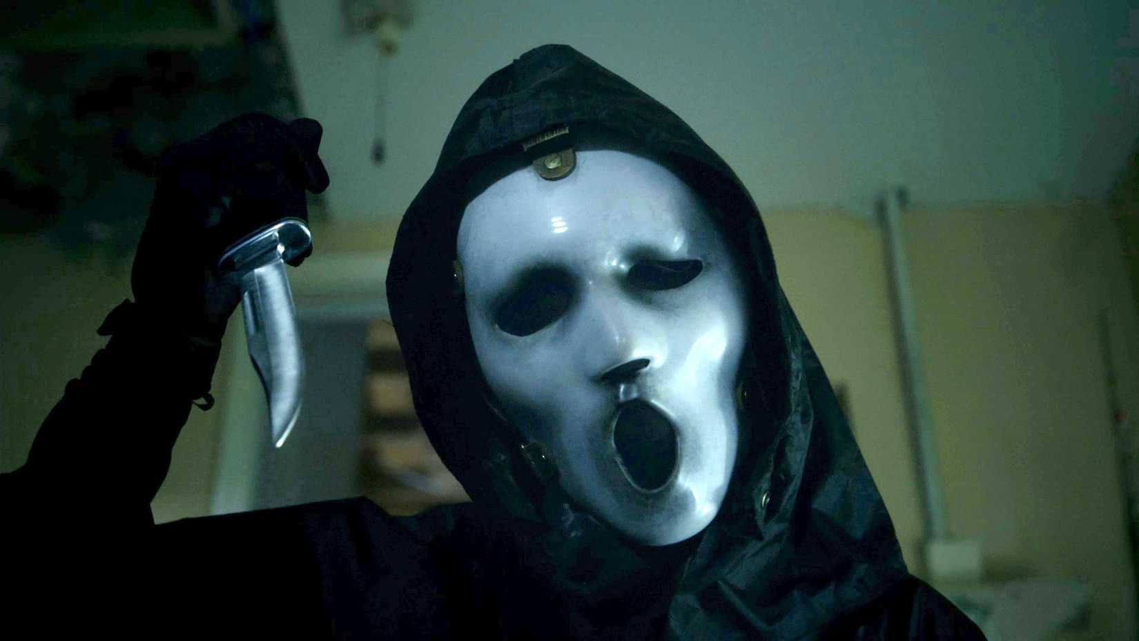 A masked killer holds up a knife in Scream: The TV Series