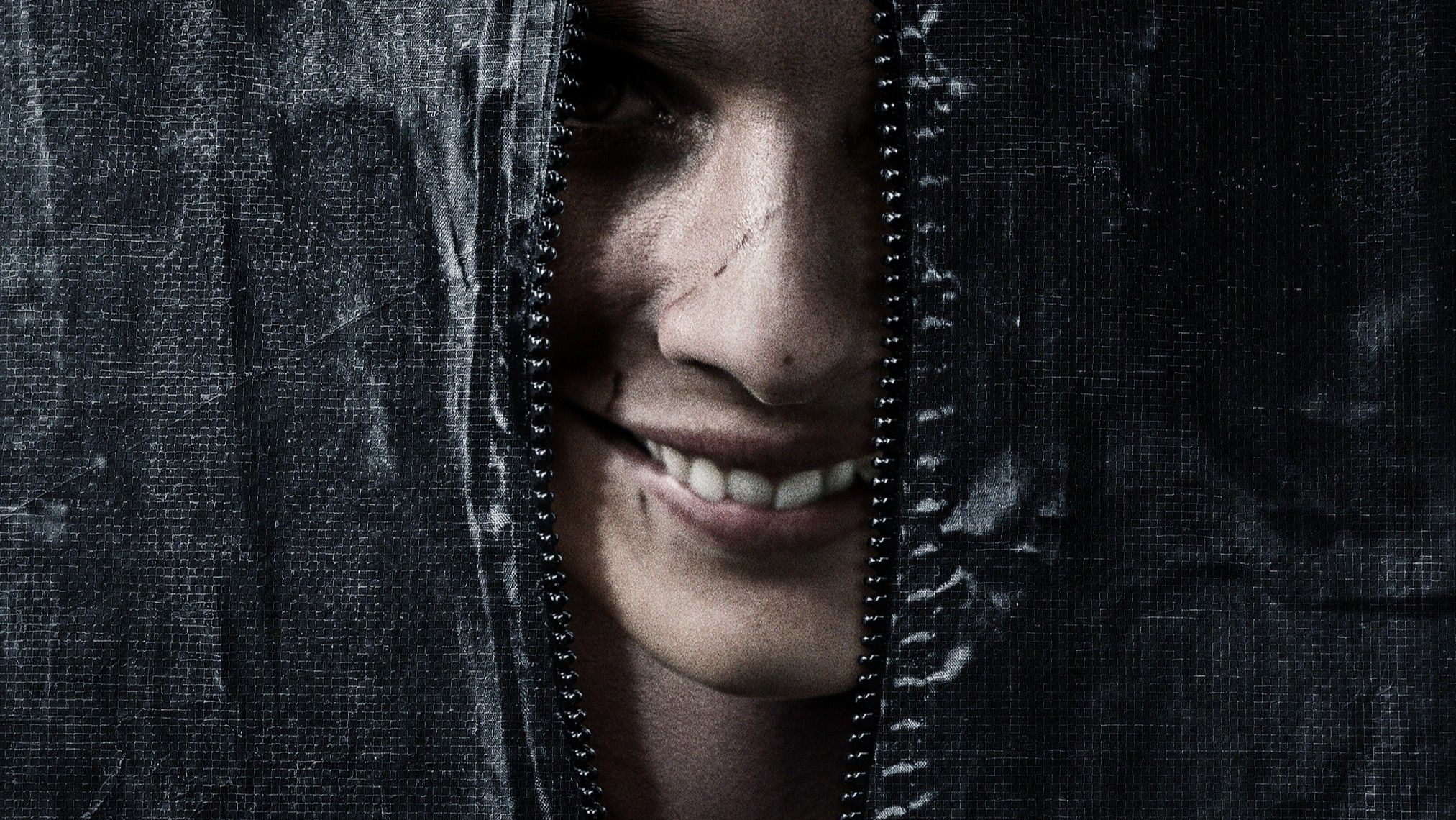 A person smiles beneath a bag in Smile movie poster