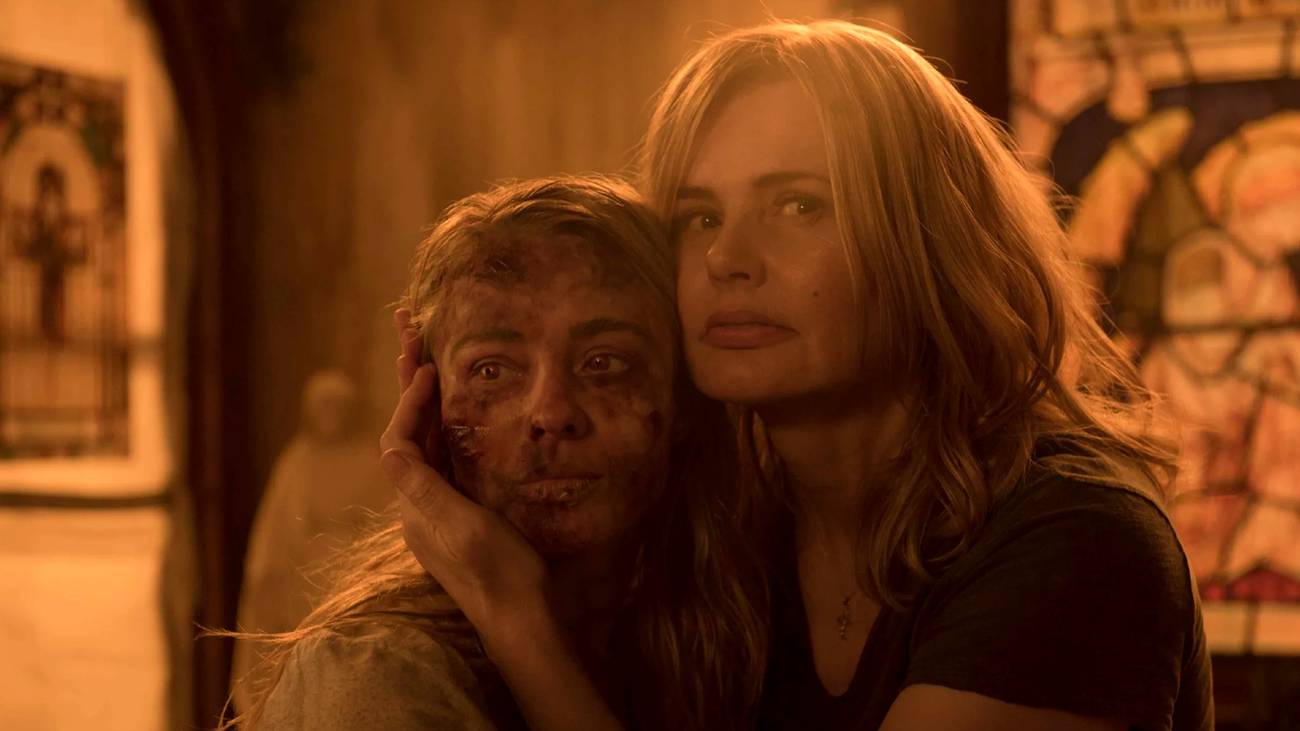 A woman holds her possessed daughter in The Exorcist tv show
