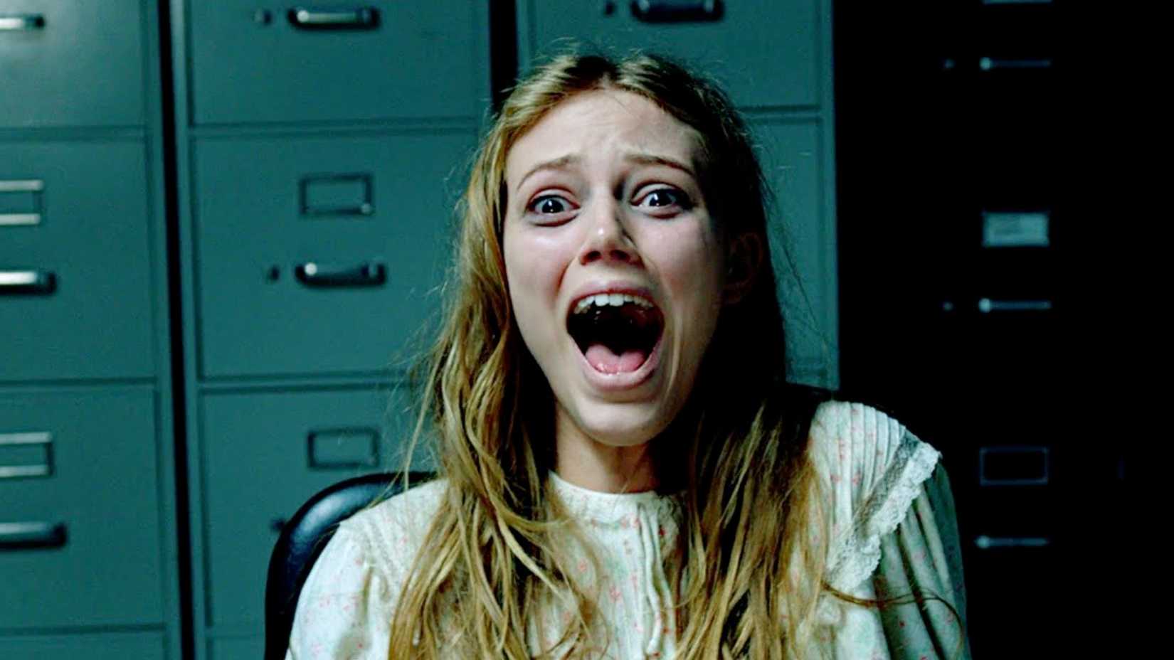 A woman screams towards the camera in Patient Seven