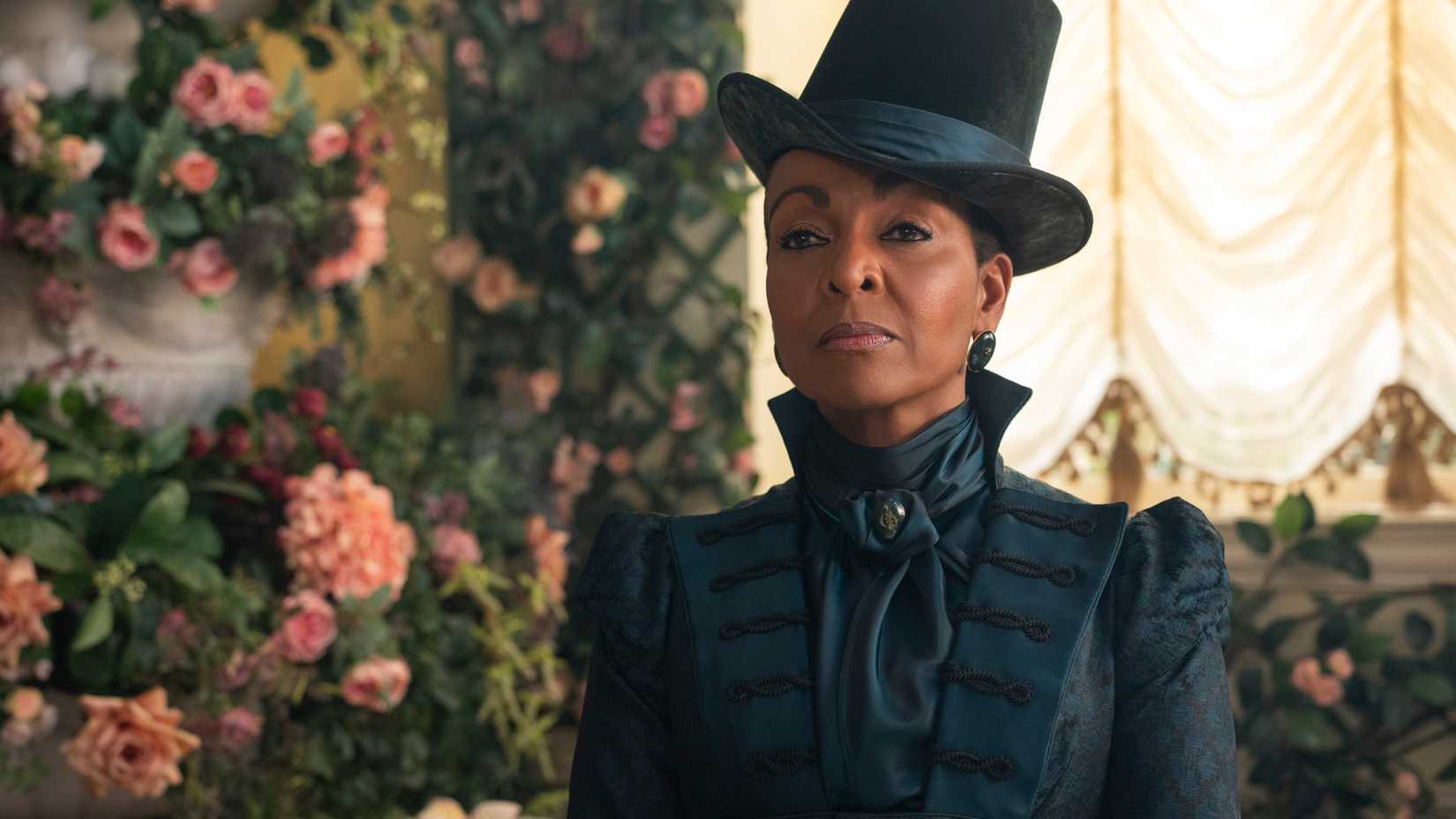 Adjoa Andoh as Lady Danbury in episode 406 of Bridgerton, standing in front of roses