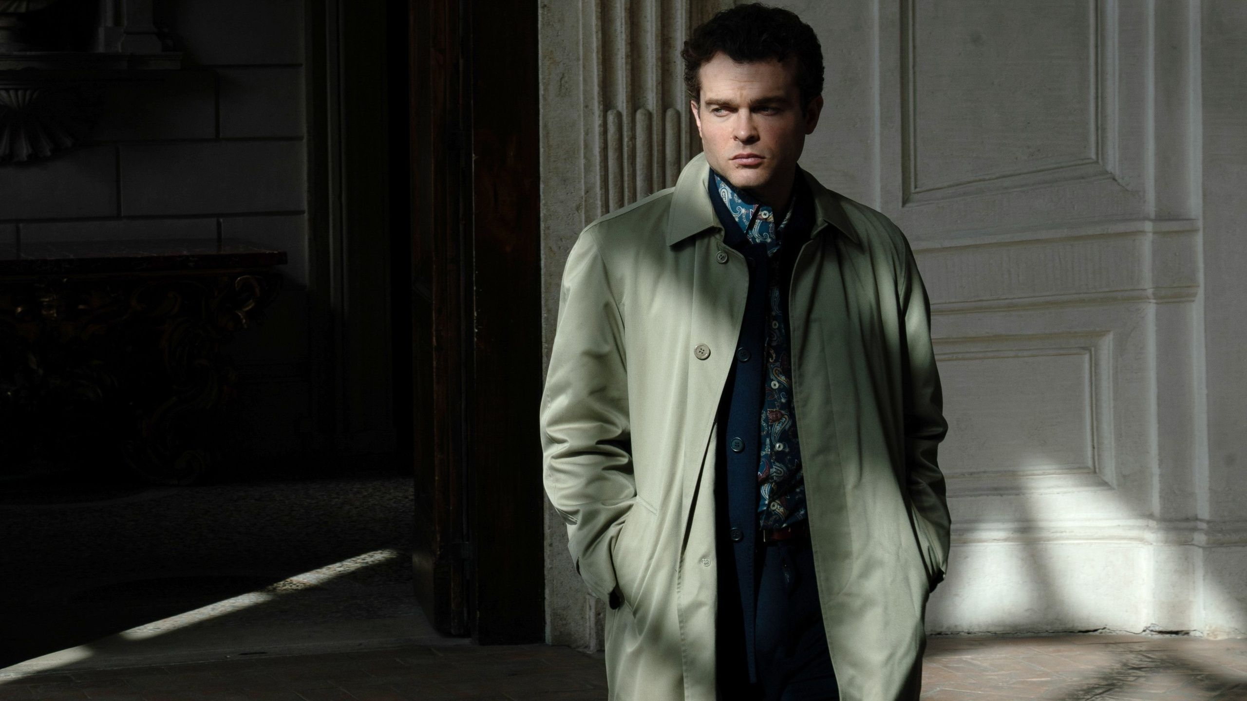 Alden Ehrenreich as Edward standing in the shadows in A Talent for Murder