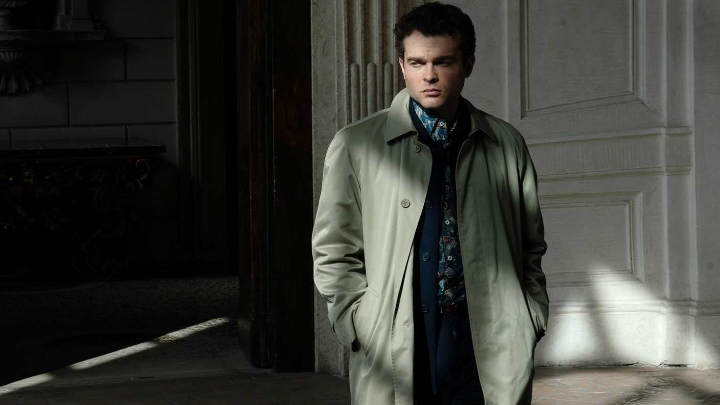 Alden Ehrenreich as Edward standing in the shadows in A Talent for Murder
