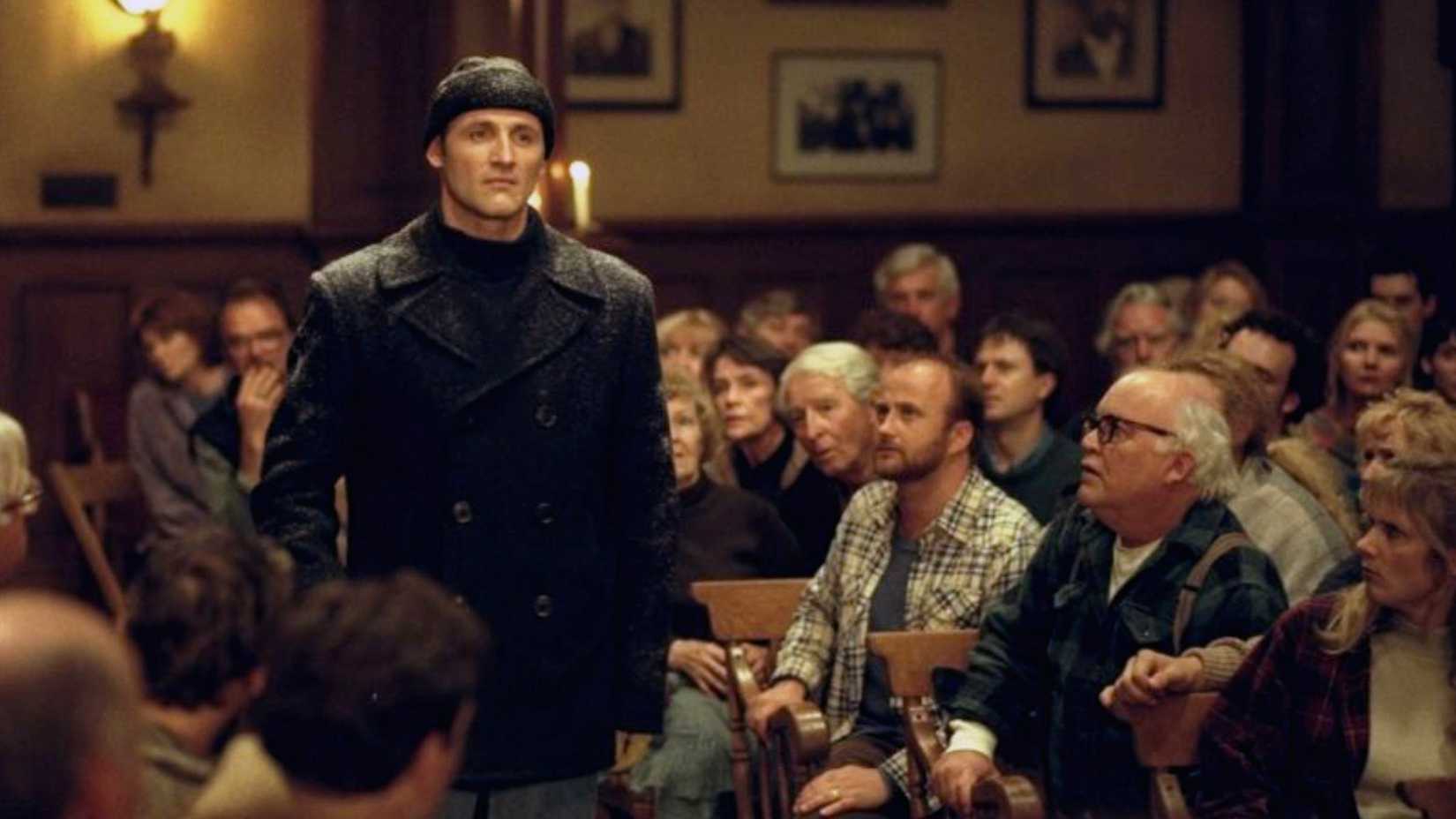 Andre Linoge stands in between townspeople in Storm of the Century