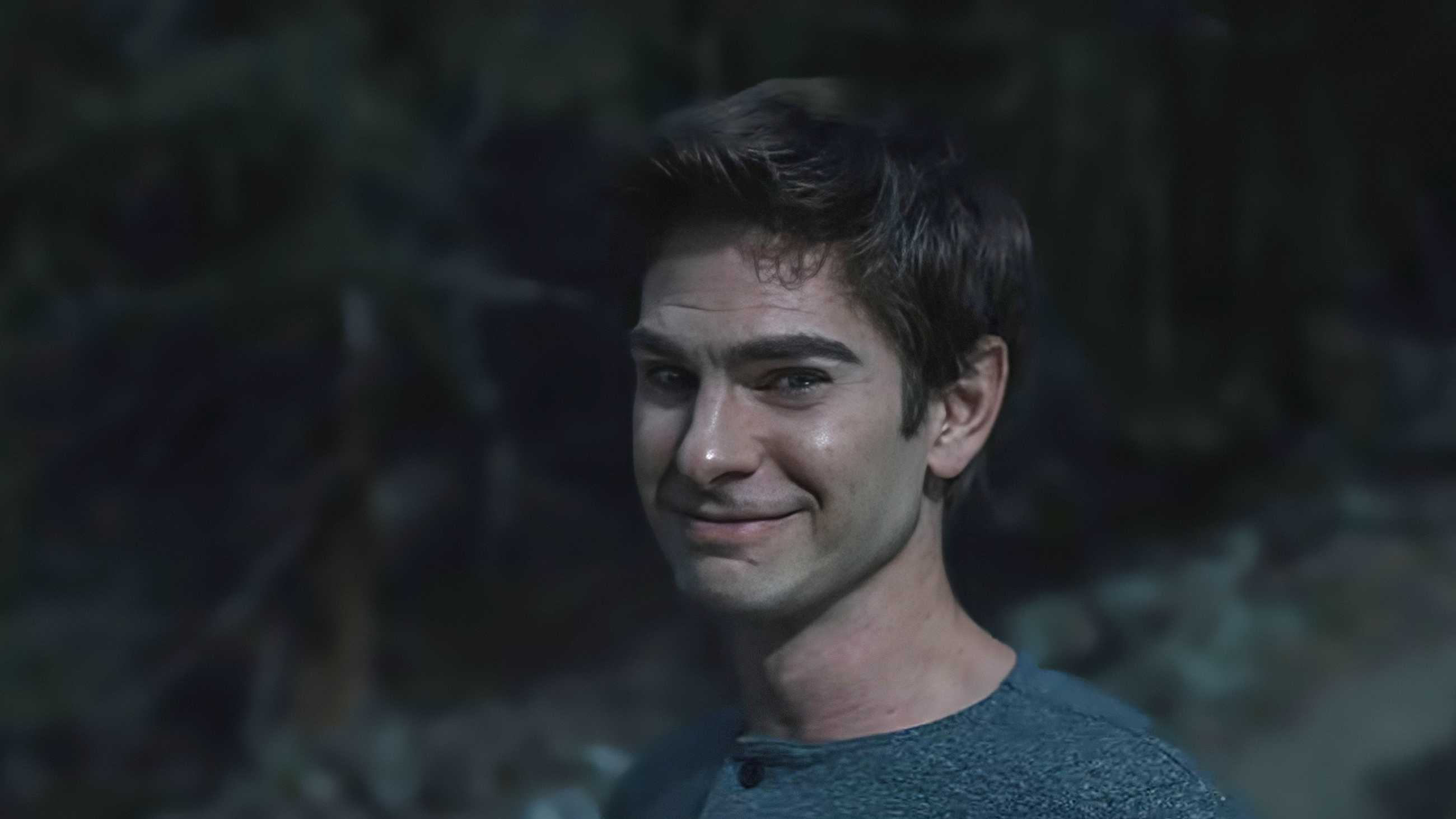 Andrew Garfield as Sam Altman smiling enigmatically in Artificial