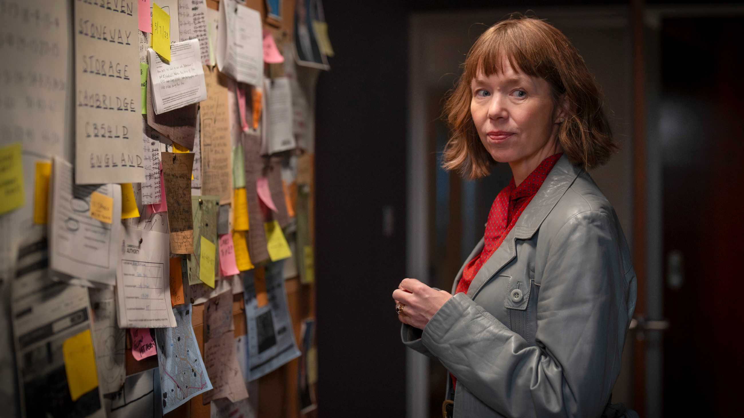 Anna Maxwell Martin as Lucy Betts-Taylor standing in front of a crime board in Ludwig season 2