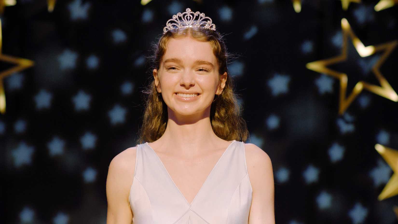 Carrie smiling on stage at prom in Prime Video's Carrie