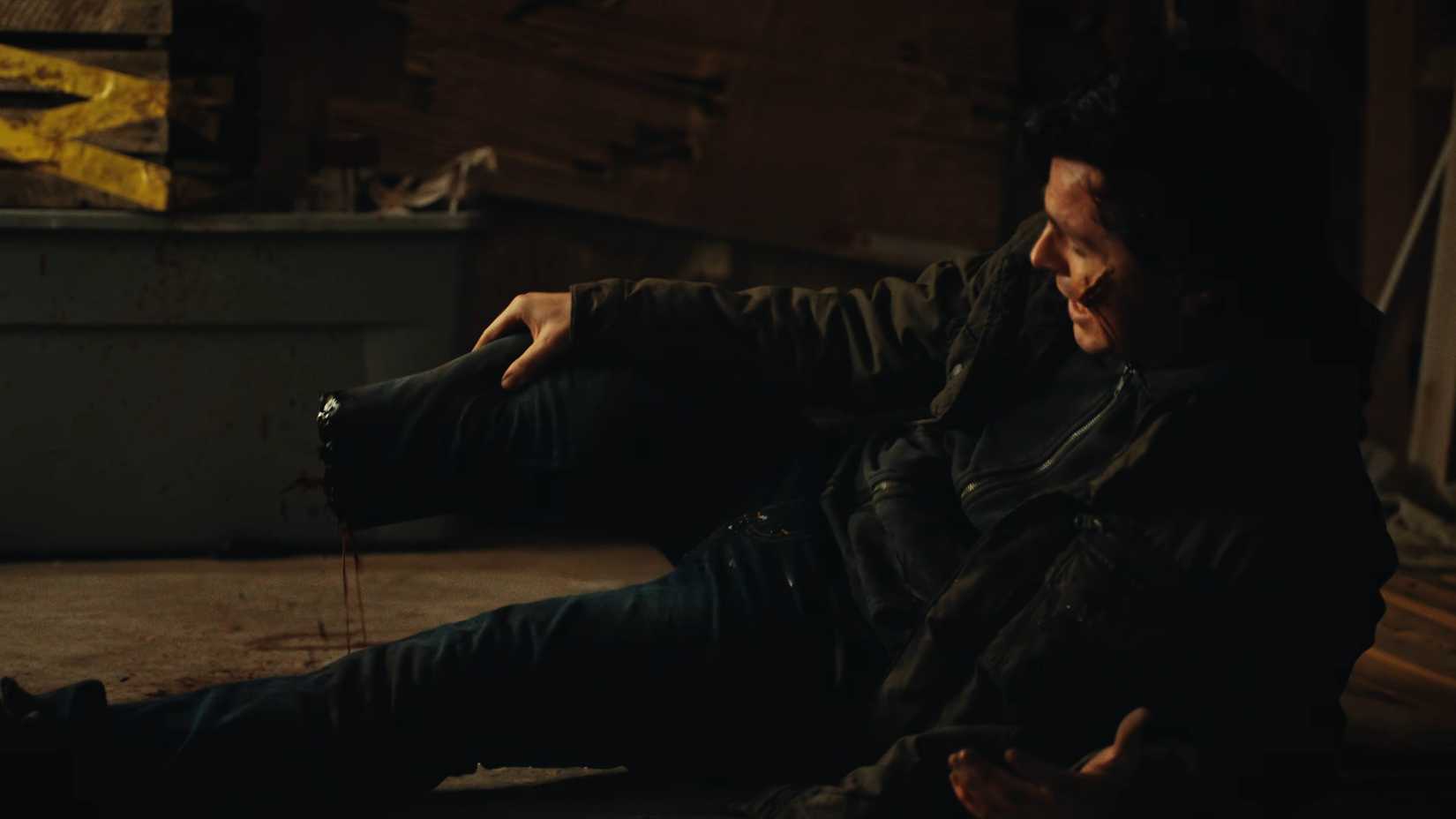 Chandler Riggs' Ethan holding his leg after it's chopped off in Biohazard