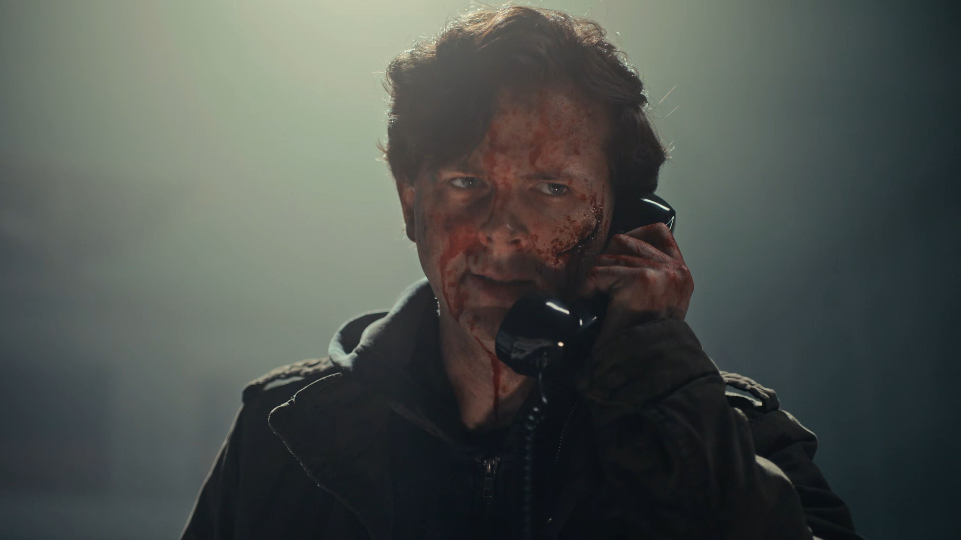 chandler-riggs-ethan-looking-angry-while-talking-into-a-phone-in-biohazard How Chandler Riggs Went From The Walking Dead To Resident Evil's Most Accurate Adaptation Yet
