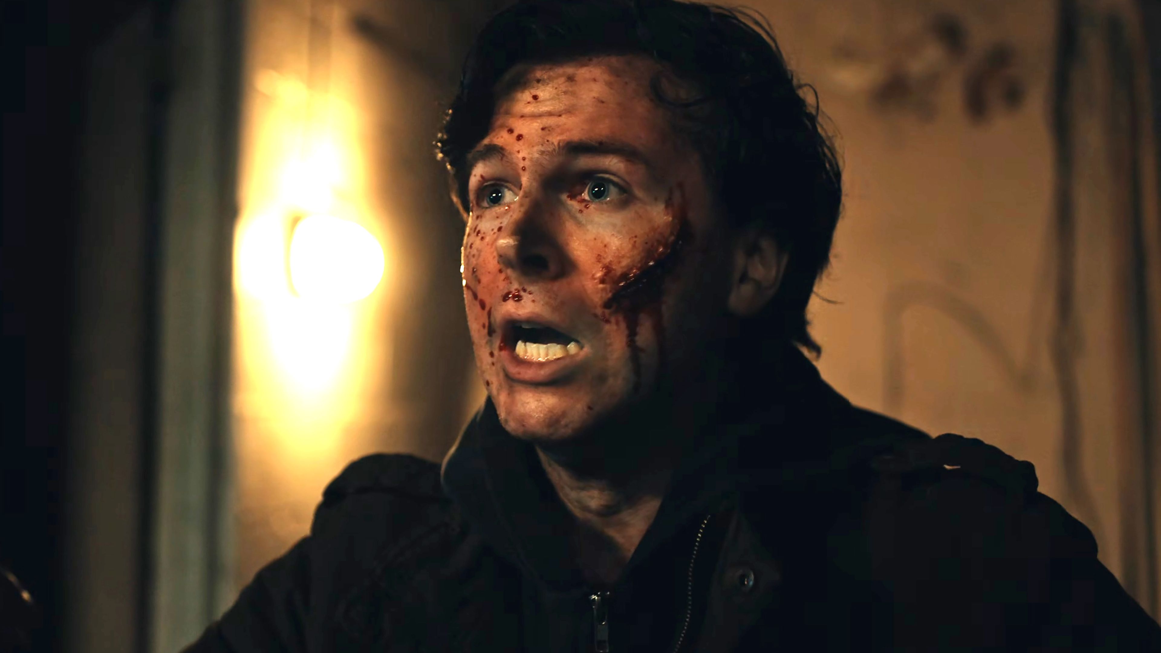 chandler-riggs-ethan-looking-shocked-with-a-cut-on-his-cheek-in-biohazard How Chandler Riggs Went From The Walking Dead To Resident Evil's Most Accurate Adaptation Yet