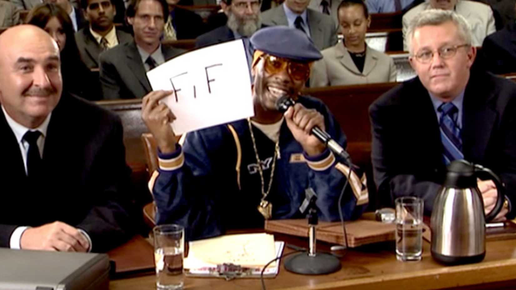 Dave Chappelle speaking into a microphone in Chappelles Show Law&Order