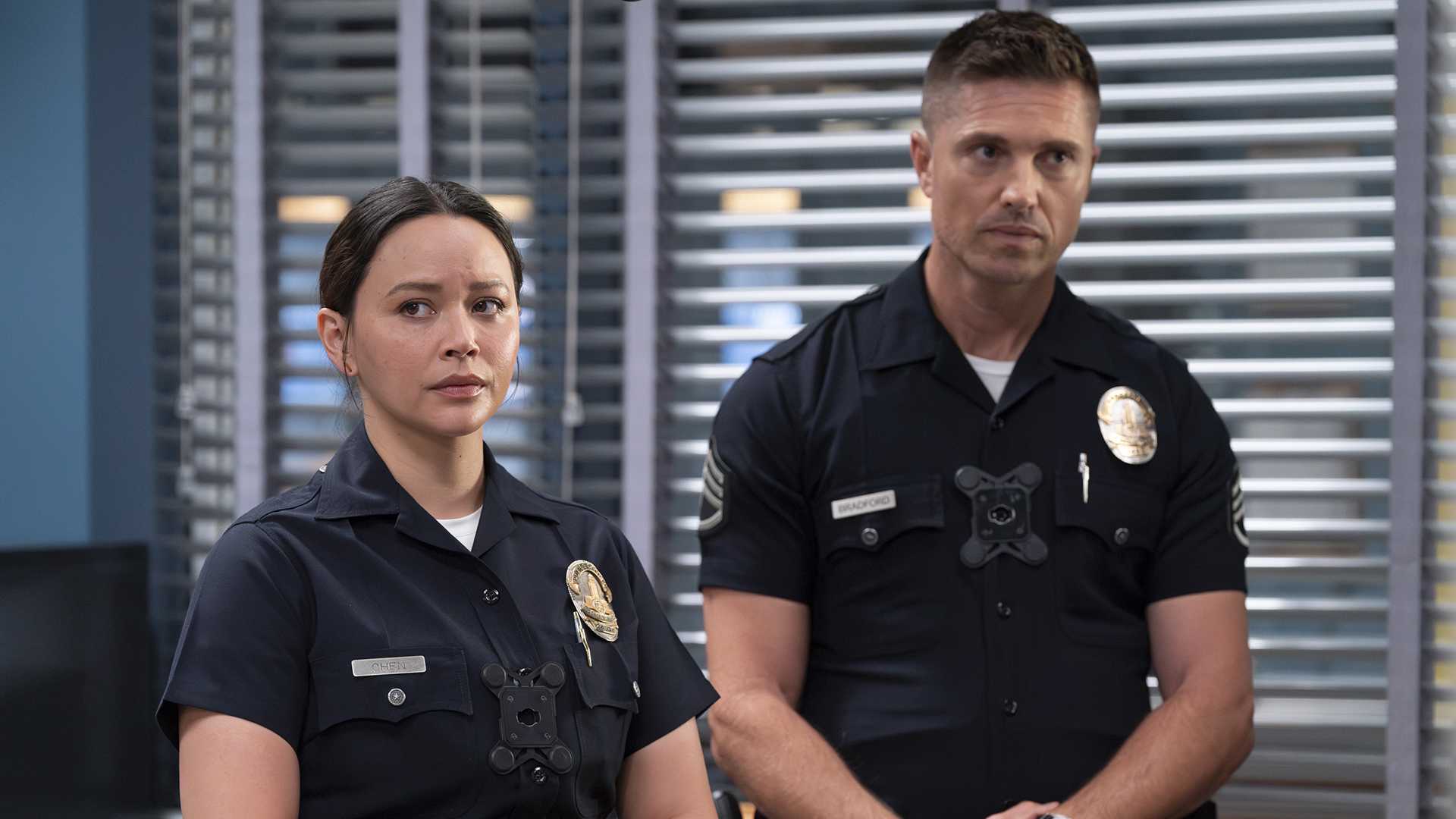 Chen and Bradford in uniform standing together in a still from The Rookie season 7