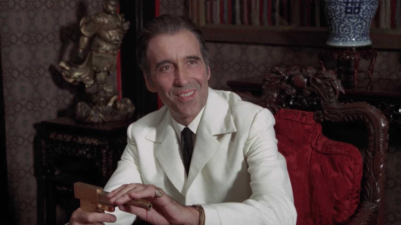 Christopher Lee as Scaramanga assembling his gun in The Man With the Golden Gun