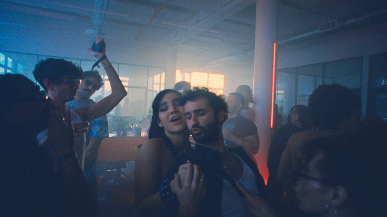 Two characters dancing in a sea of clubbers in Club Kid