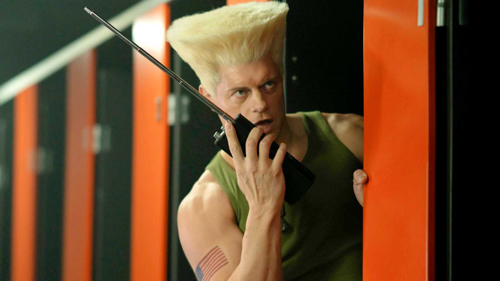 Cody Rhodes as Guile using a walkie talkie in Street Fighter 2026
