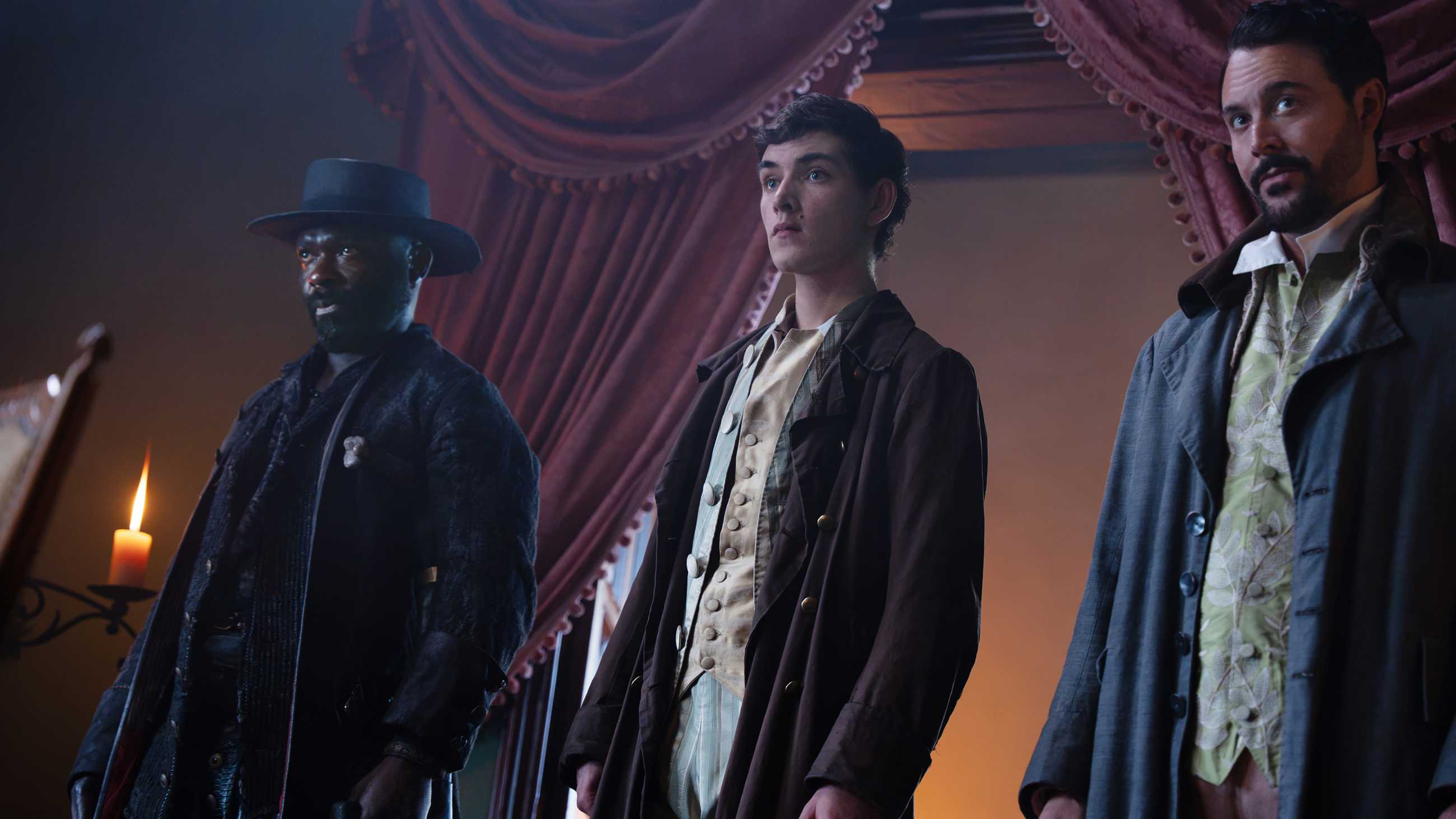 David Oyelowo's Long John Silver, Tom Sweet's Jim and Jack Huston's Aaron Graham looking intently at something in Treasure Island
