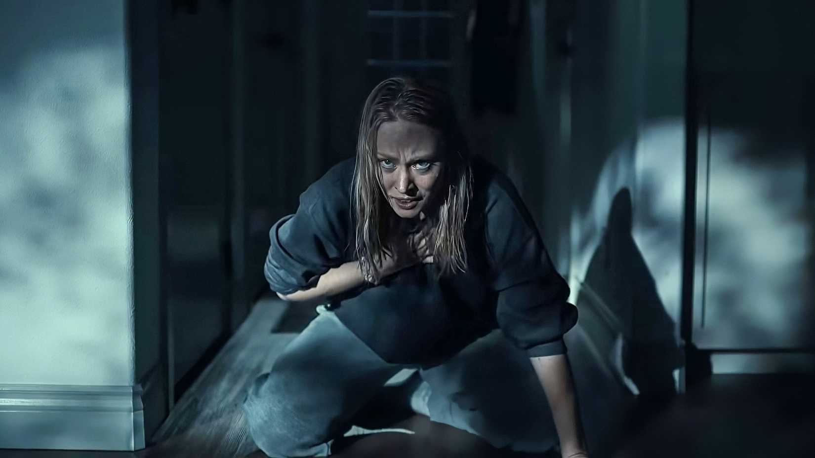 Deborah Ann Woll kneeling with her hand on her chest looking into camera in The Cycle
