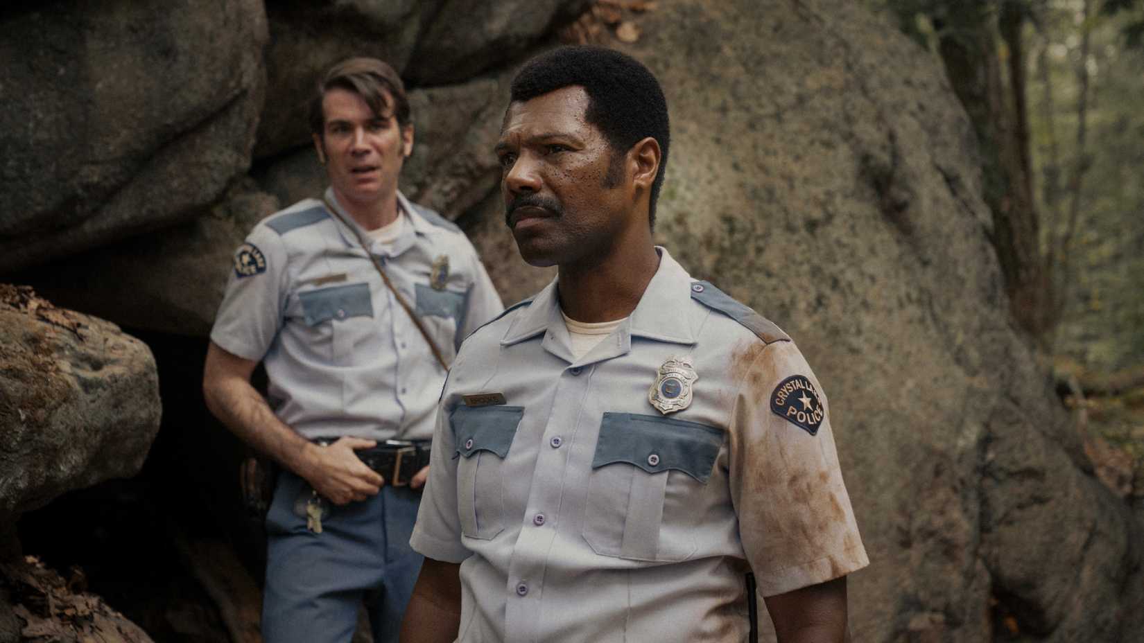 Dorf and Lee look suspicious while standing in the woods in Crystal Lake season 1