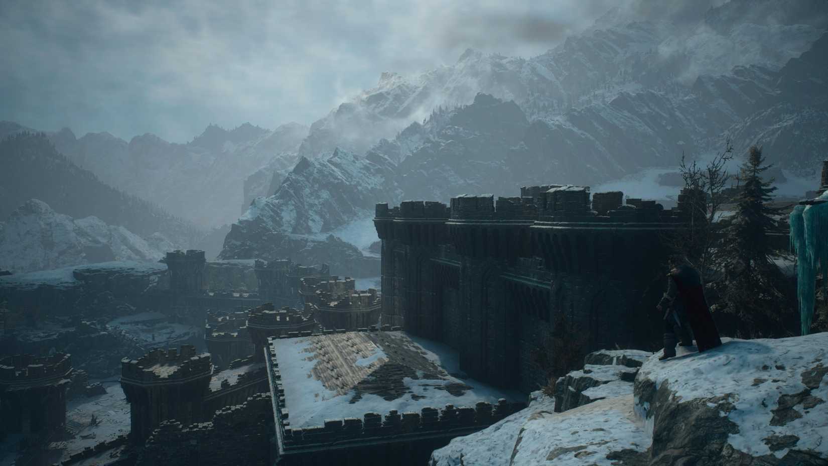 A character stands on a cliff overlooking a stone fort, with snow-covered mountains in the distance.