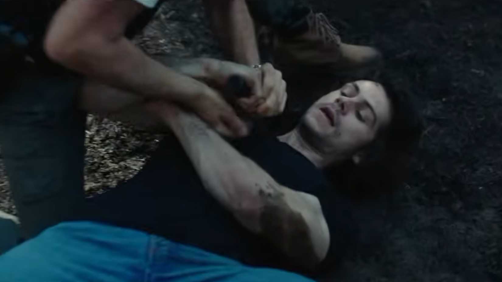 Dylan O'Brien on the floor at knife point in american assassin